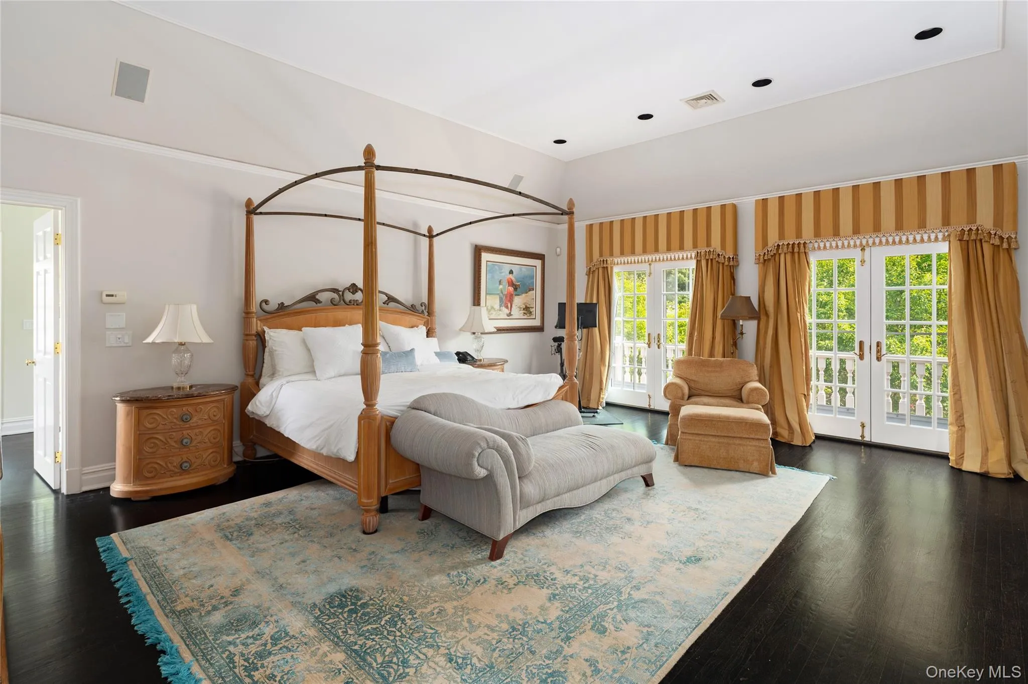 Bedroom featuring access to outside, multiple windows, dark wood-style floors, and ornamental molding Bedroom featuring access to outside, multiple windows, dark wood-style floors, and ornamental molding