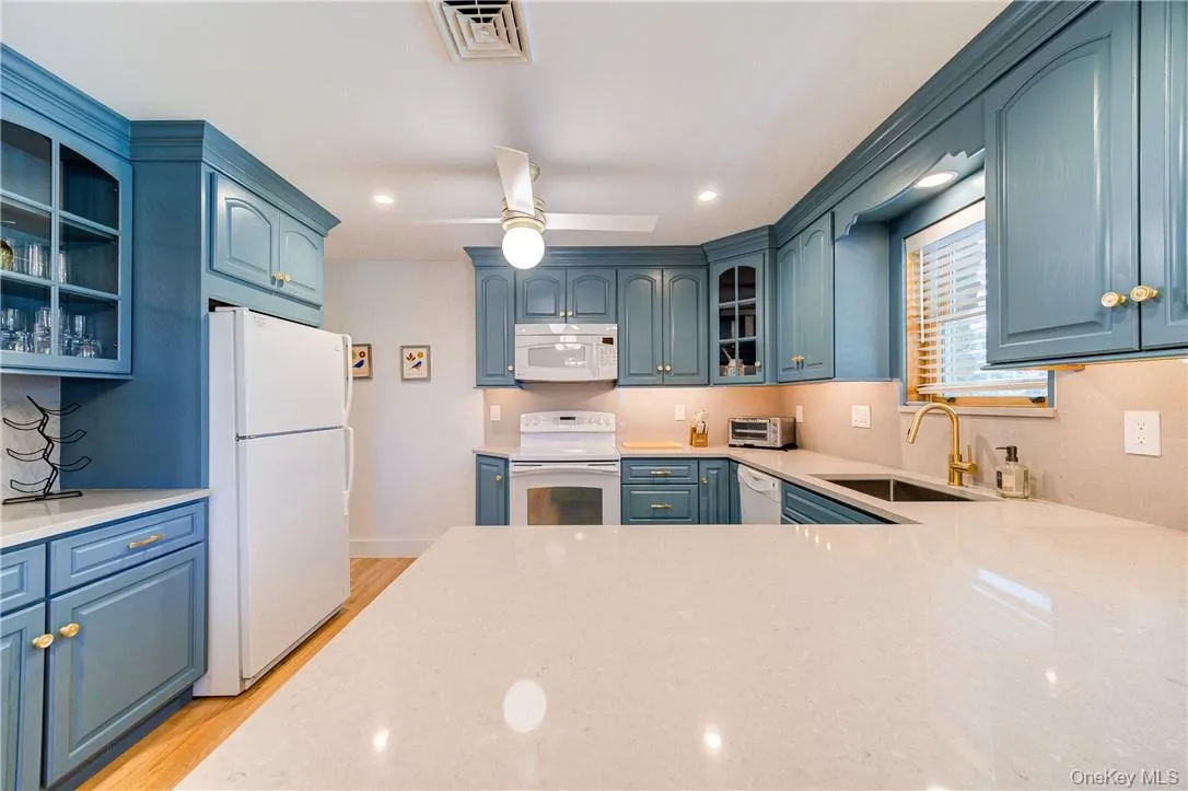 Gleaming stone countertops and a built-in coffee bar area. Gleaming stone countertops and a built-in coffee bar area.