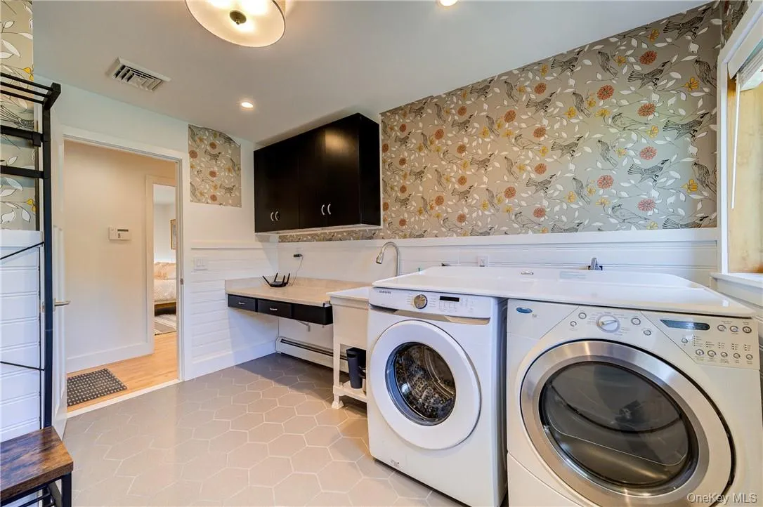 High end washer dryer set in this spacious mud room. High end washer dryer set in this spacious mud room.