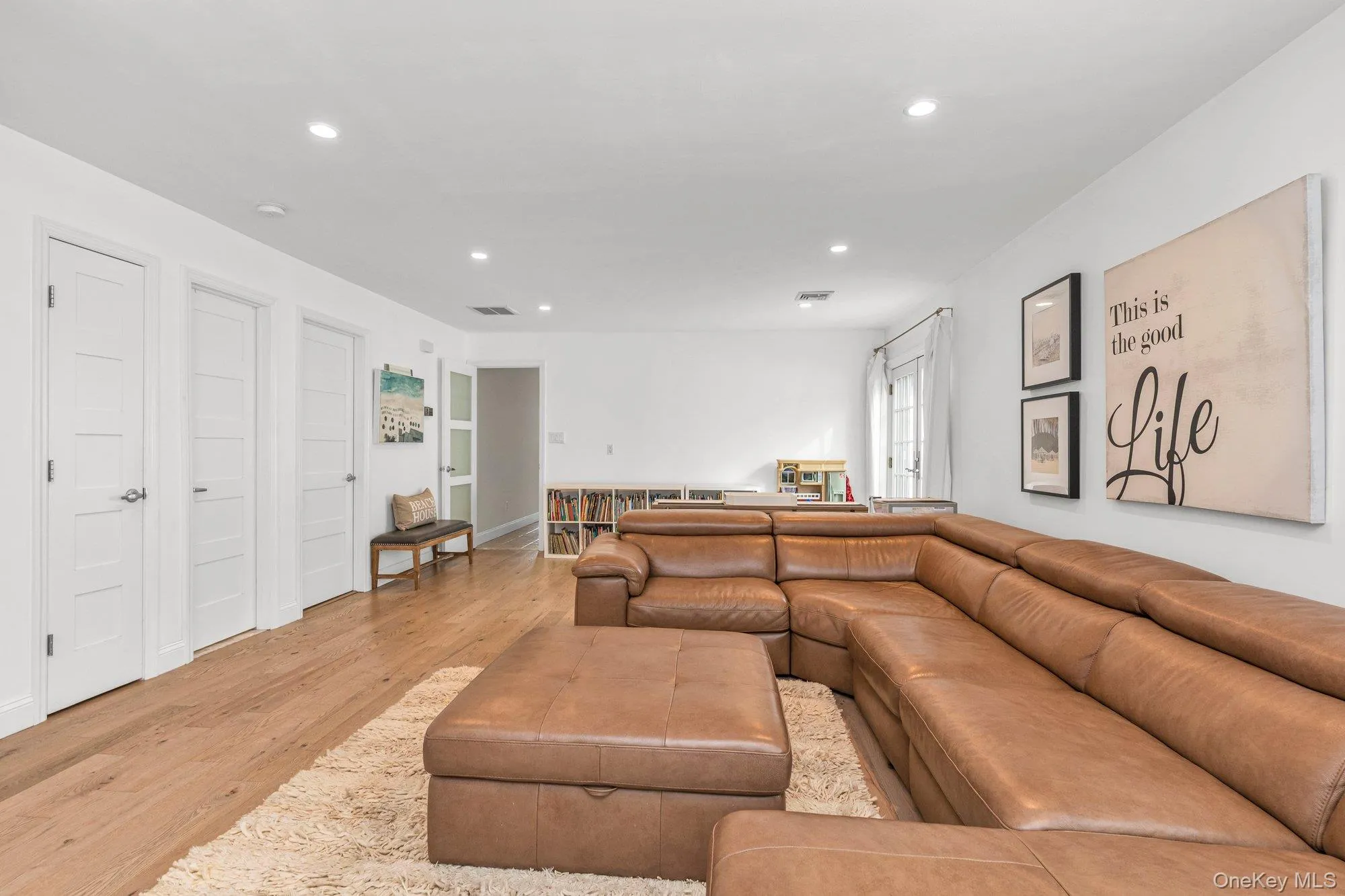 Living area with wood finished floors and recessed lighting Living area with wood finished floors and recessed lighting