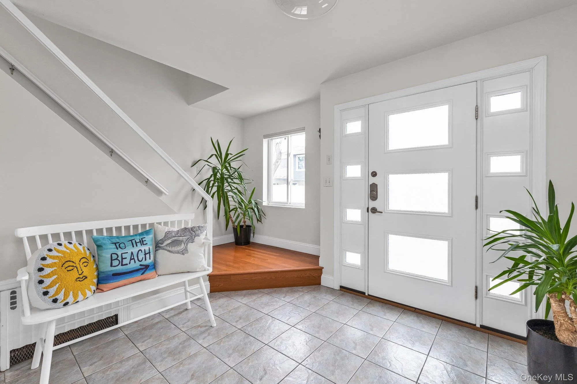 Foyer featuring baseboards and light tile patterned floors Foyer featuring baseboards and light tile patterned floors