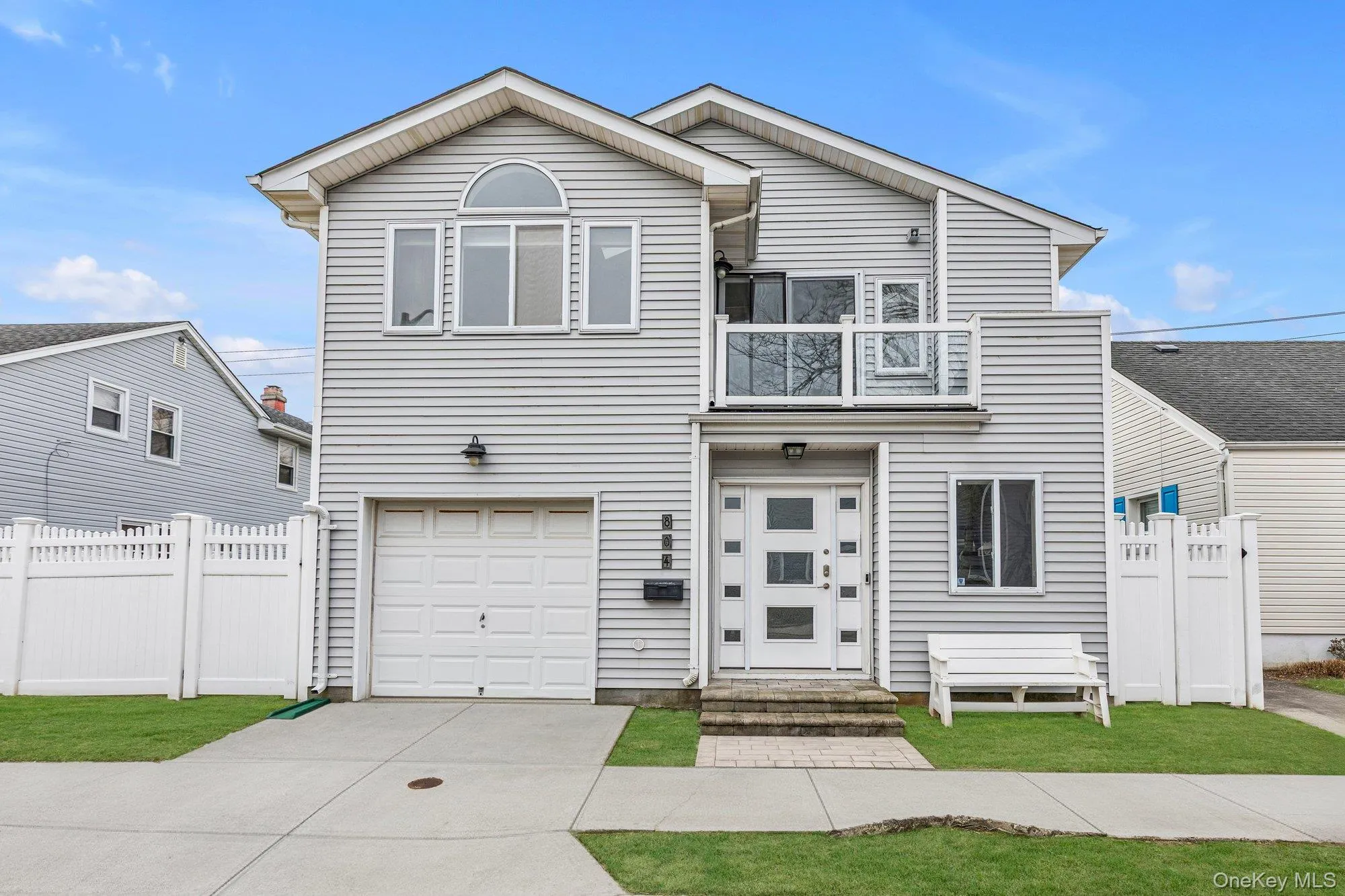 Traditional-style home featuring an attached garage and driveway Traditional-style home featuring an attached garage and driveway