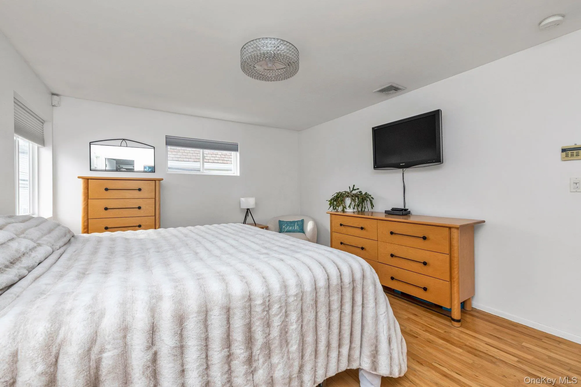Bedroom featuring light wood-type flooring and baseboards Bedroom featuring light wood-type flooring and baseboards