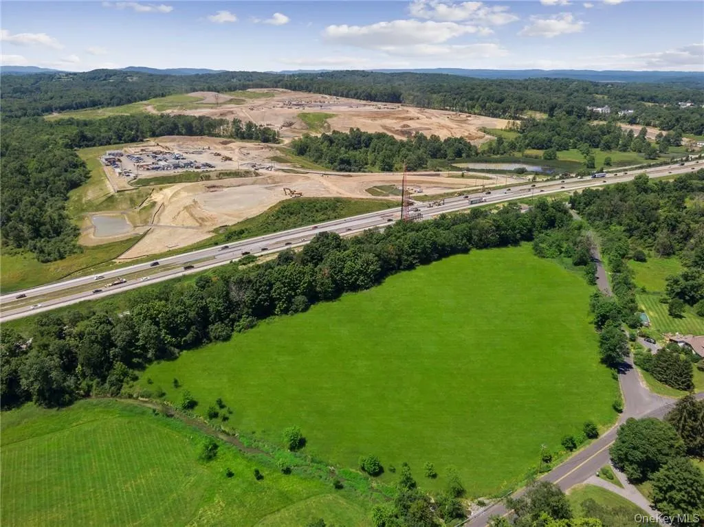 Looking approximately southwest, toward New Jersey and Pennsylvania. The red rig near the highway is a pile driver preparing the new entrance/exit from the highway. Looking approximately southwest, toward New Jersey and Pennsylvania. The red rig near the highway is a pile driver preparing the new entrance/exit from the highway.