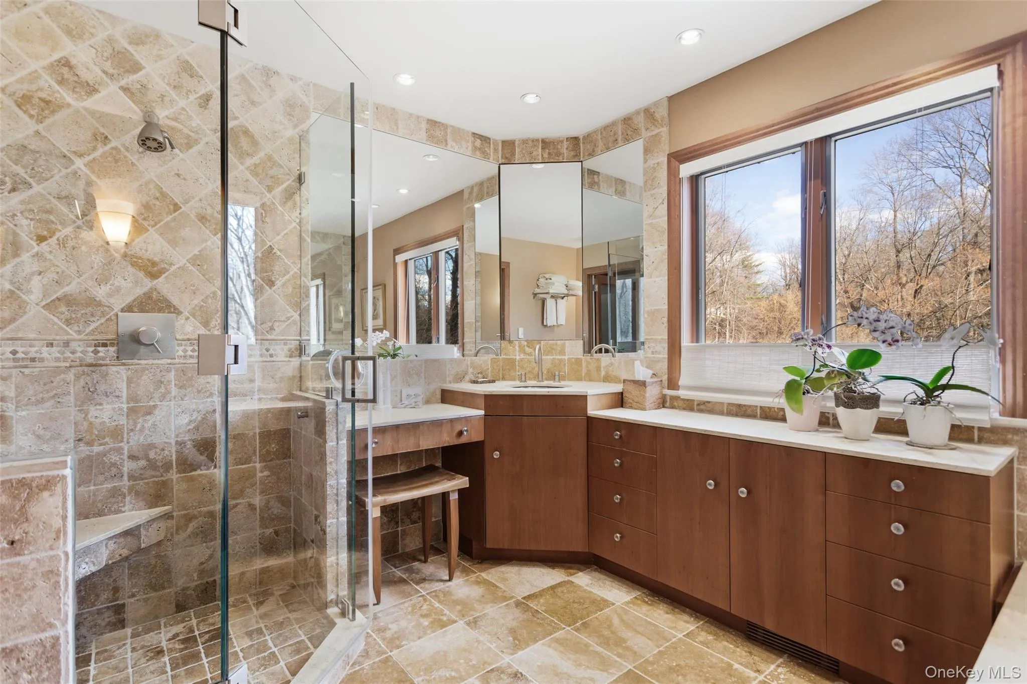 Full ensuite bath featuring vanity, a stall shower, and soaking tub Full ensuite bath featuring vanity, a stall shower, and soaking tub