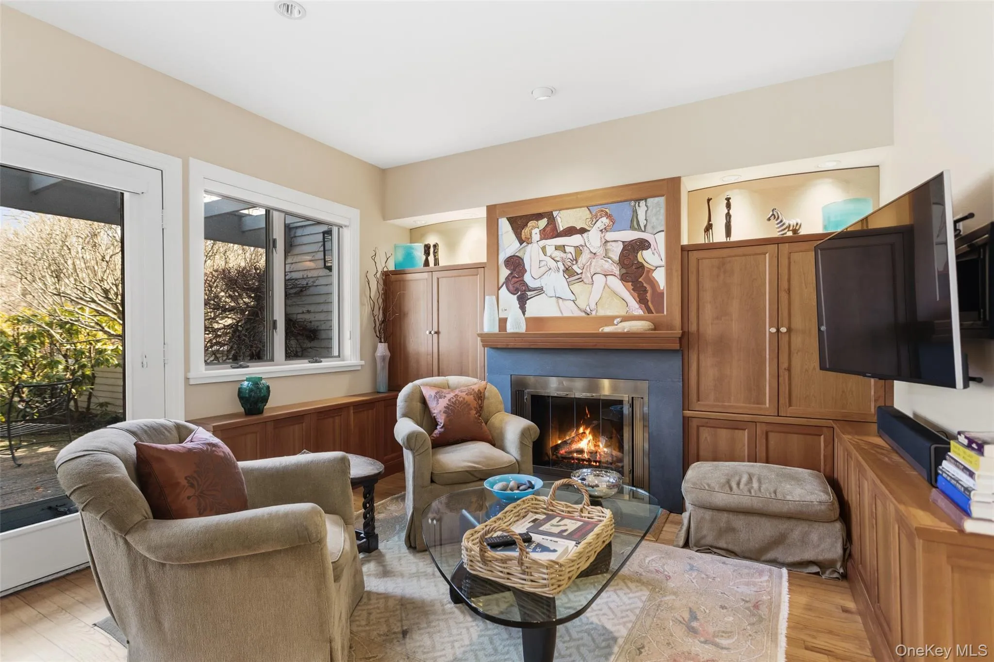Den with wood-burning fireplace and custom built-ins Den with wood-burning fireplace and custom built-ins