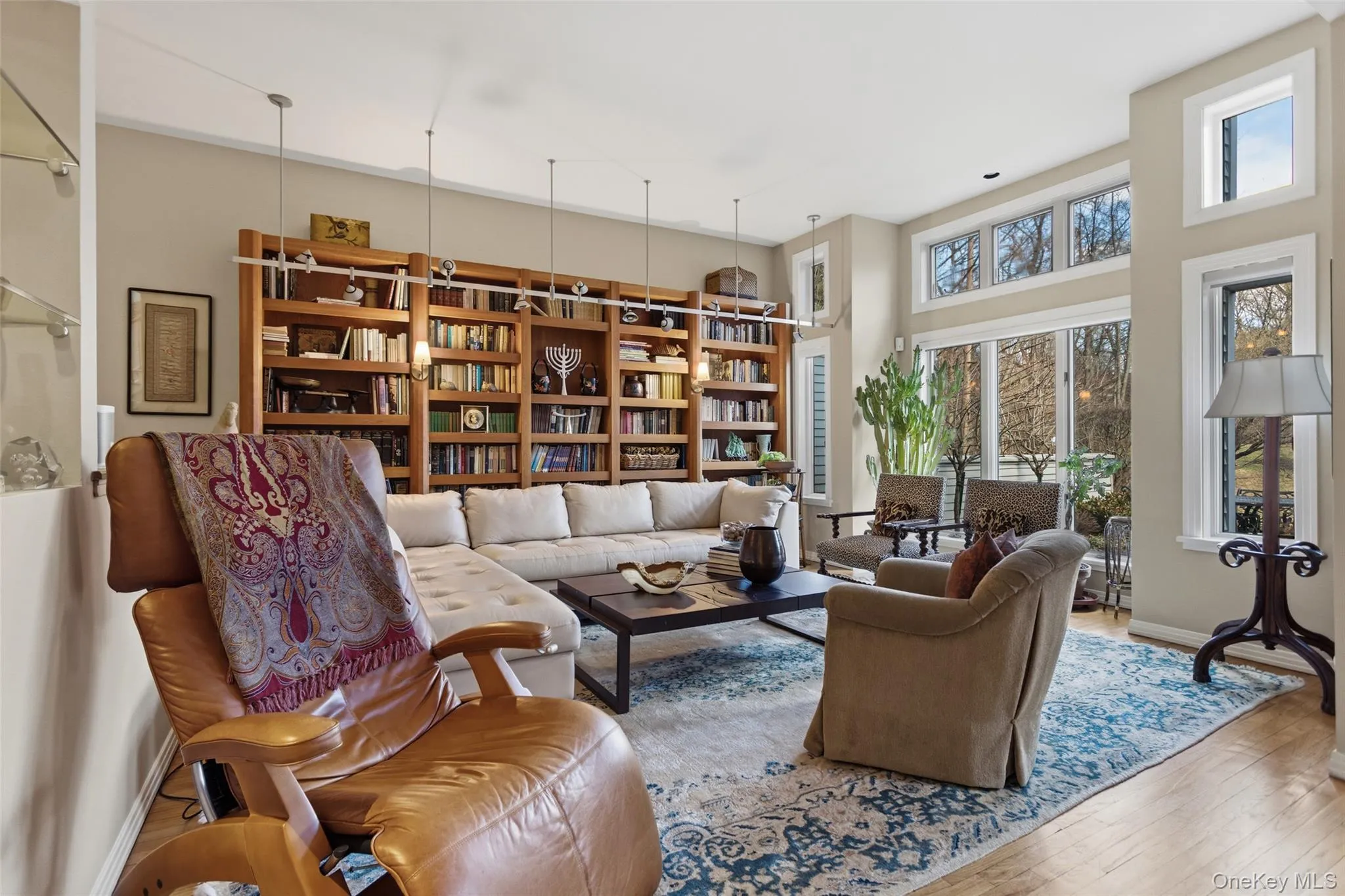 Family room with custom built-ins and giant windows with views of the pond Family room with custom built-ins and giant windows with views of the pond