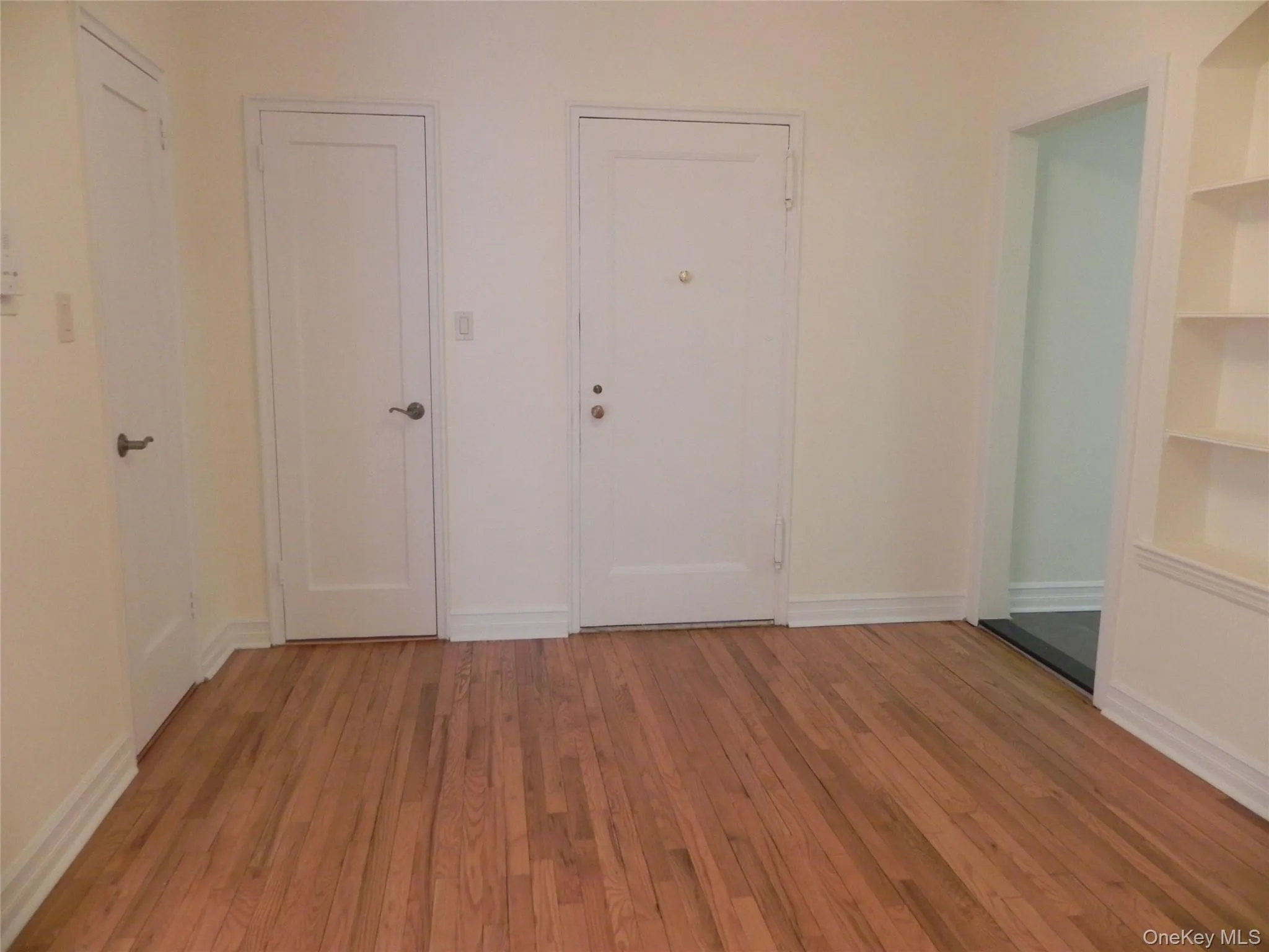 Entry with built in shelves and hardwood flooring Entry with built in shelves and hardwood flooring