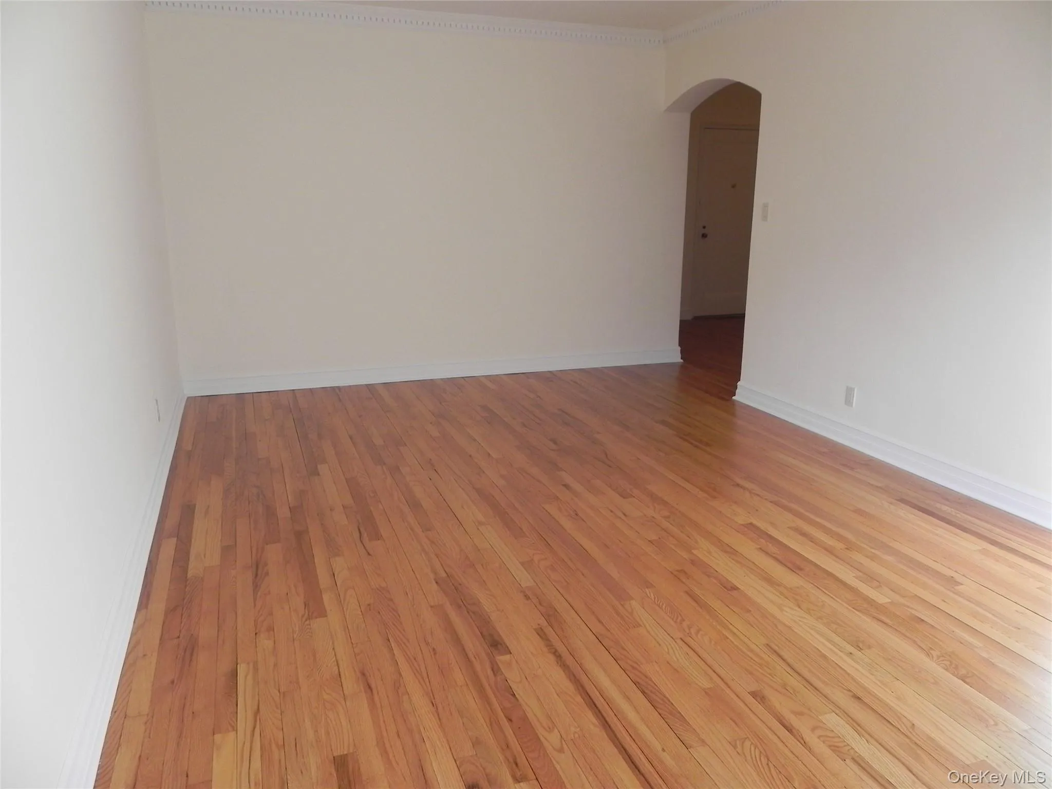 Living room with crown molding and hardwood flooring Living room with crown molding and hardwood flooring