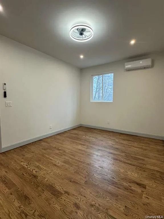 Empty room with dark wood-style floors and recessed lighting Empty room with dark wood-style floors and recessed lighting