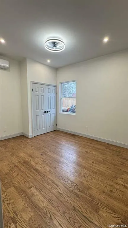 Unfurnished bedroom with wood finished floors, recessed lighting, and a closet Unfurnished bedroom with wood finished floors, recessed lighting, and a closet