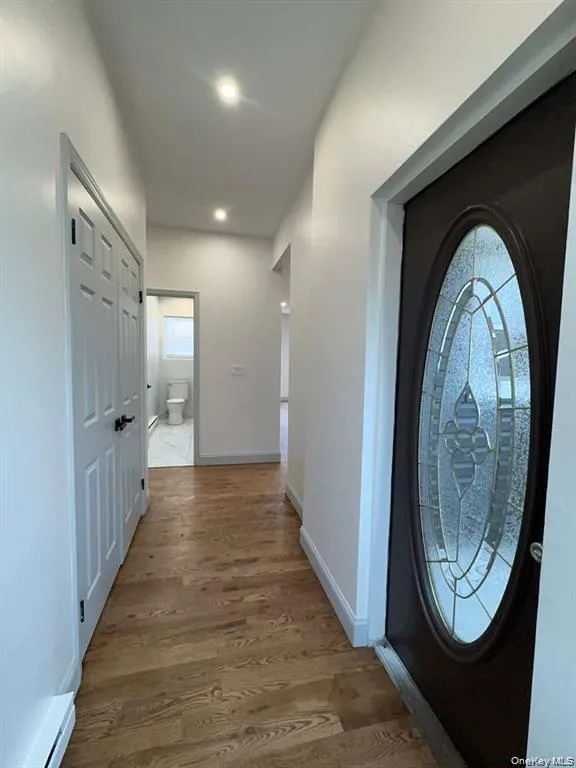Foyer featuring wood finished floors and baseboards Foyer featuring wood finished floors and baseboards