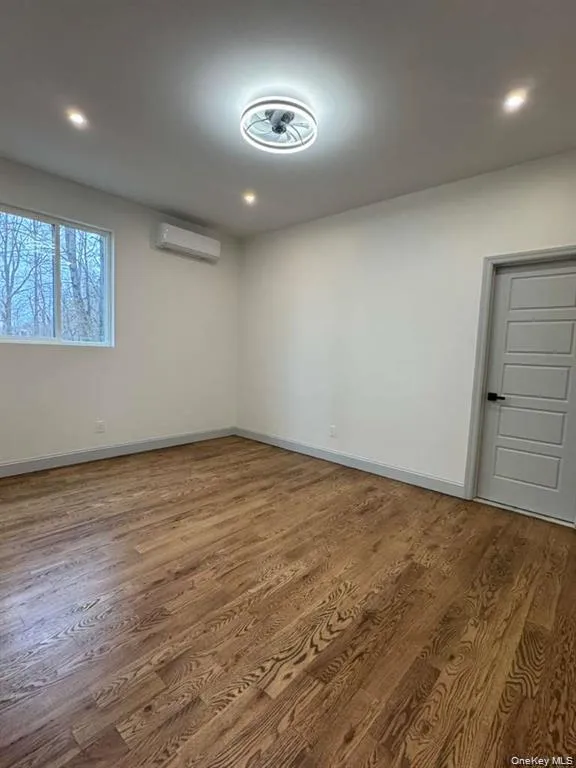 Unfurnished room with dark wood-style floors and recessed lighting Unfurnished room with dark wood-style floors and recessed lighting