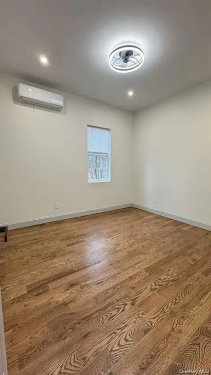 Unfurnished room with wood finished floors Unfurnished room with wood finished floors