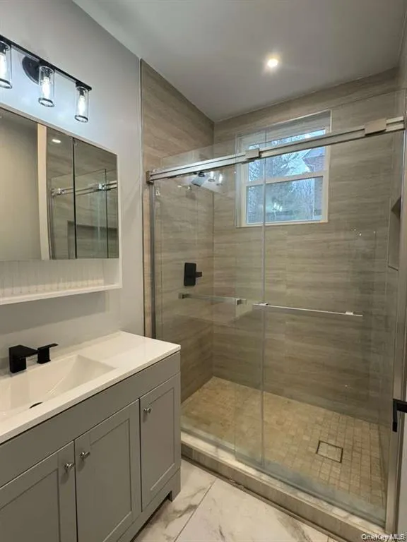 Full bath with vanity and a shower stall Full bath with vanity and a shower stall