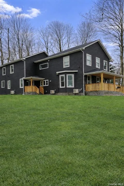Rear view of house featuring a lawn Rear view of house featuring a lawn