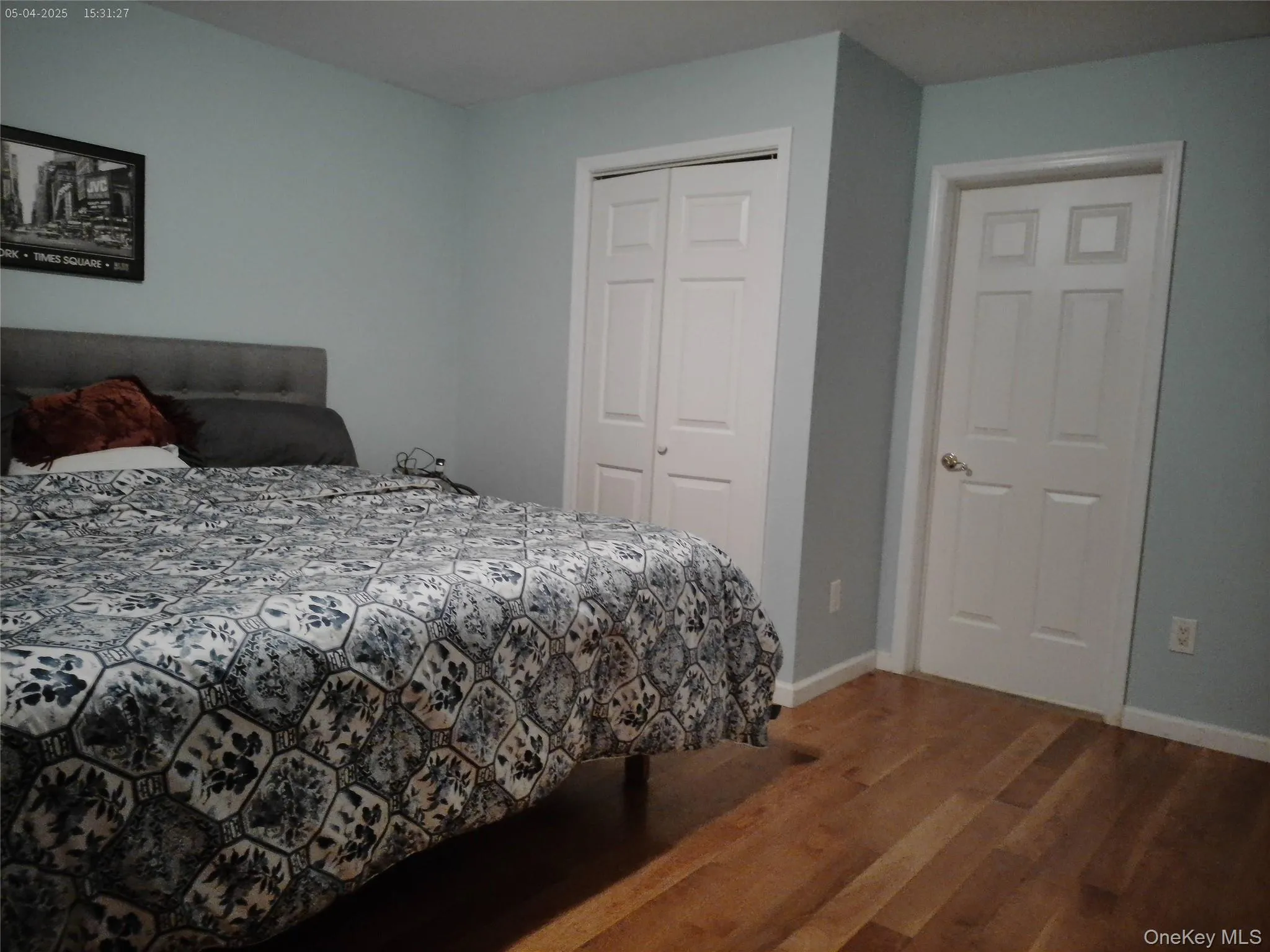 Bedroom with baseboards, a closet, and wood finished floors Bedroom with baseboards, a closet, and wood finished floors