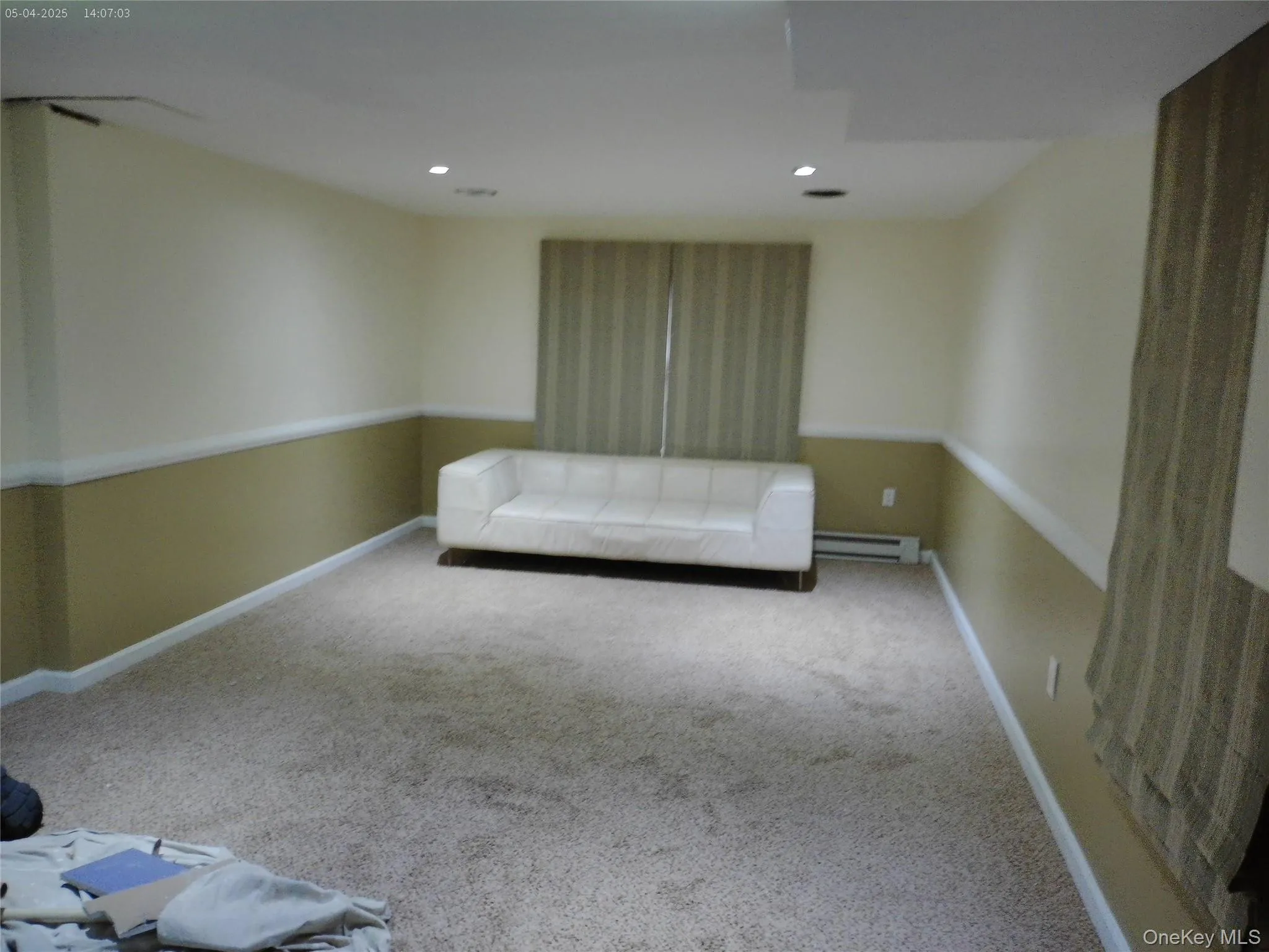 Finished basement featuring baseboard heating, carpet, baseboards, and recessed lighting Finished basement featuring baseboard heating, carpet, baseboards, and recessed lighting
