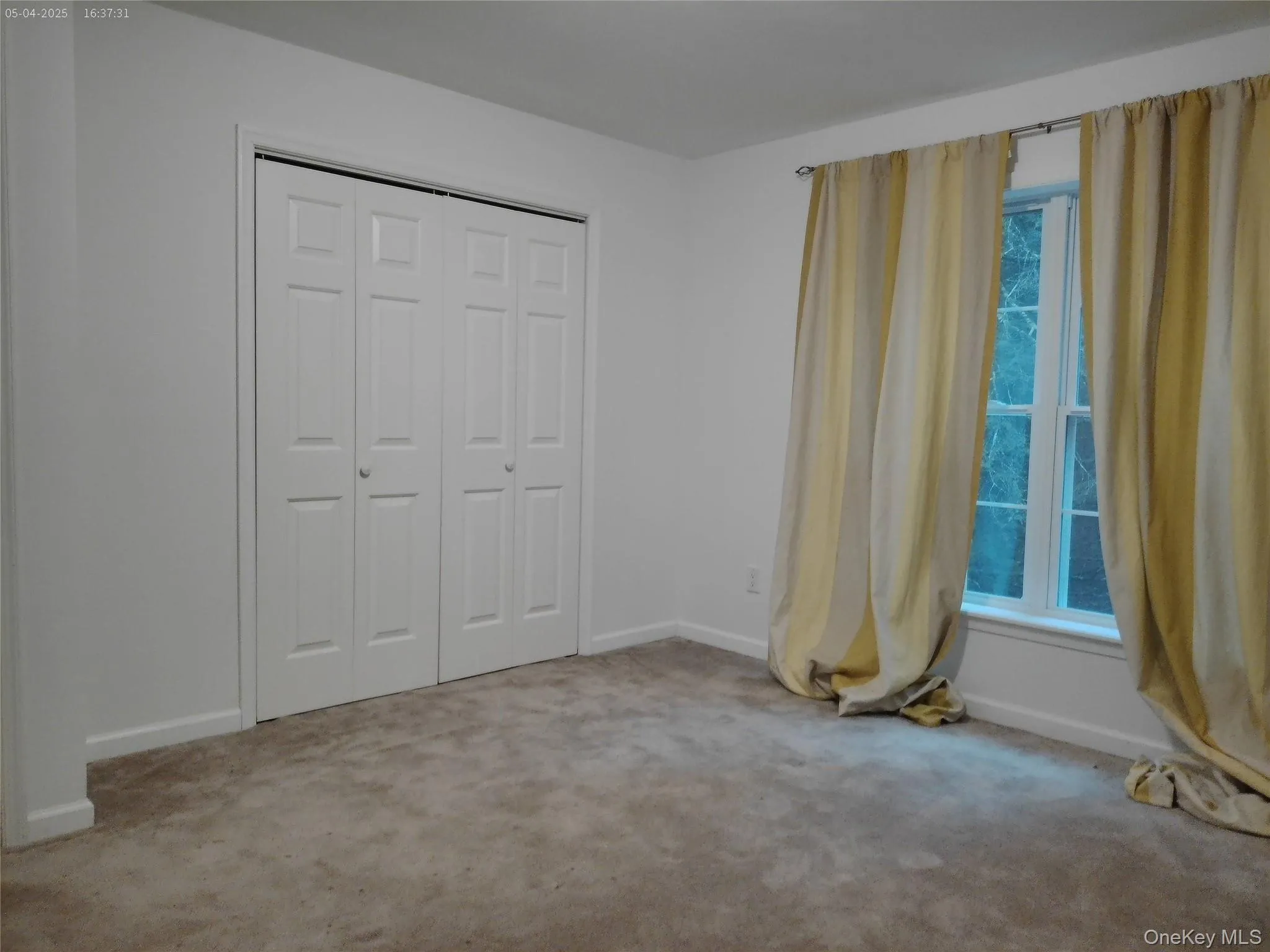 Unfurnished bedroom with baseboards, a closet, and carpet flooring Unfurnished bedroom with baseboards, a closet, and carpet flooring