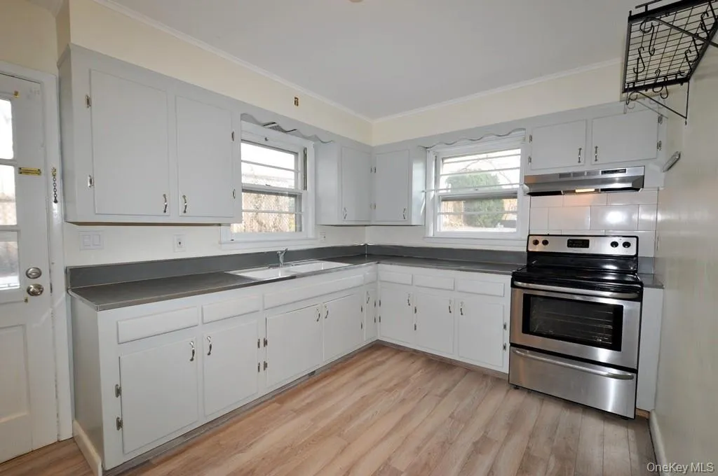 Large Eat-in Kitchen with a stainless steel range and refrigerator. Large Eat-in Kitchen with a stainless steel range and refrigerator.