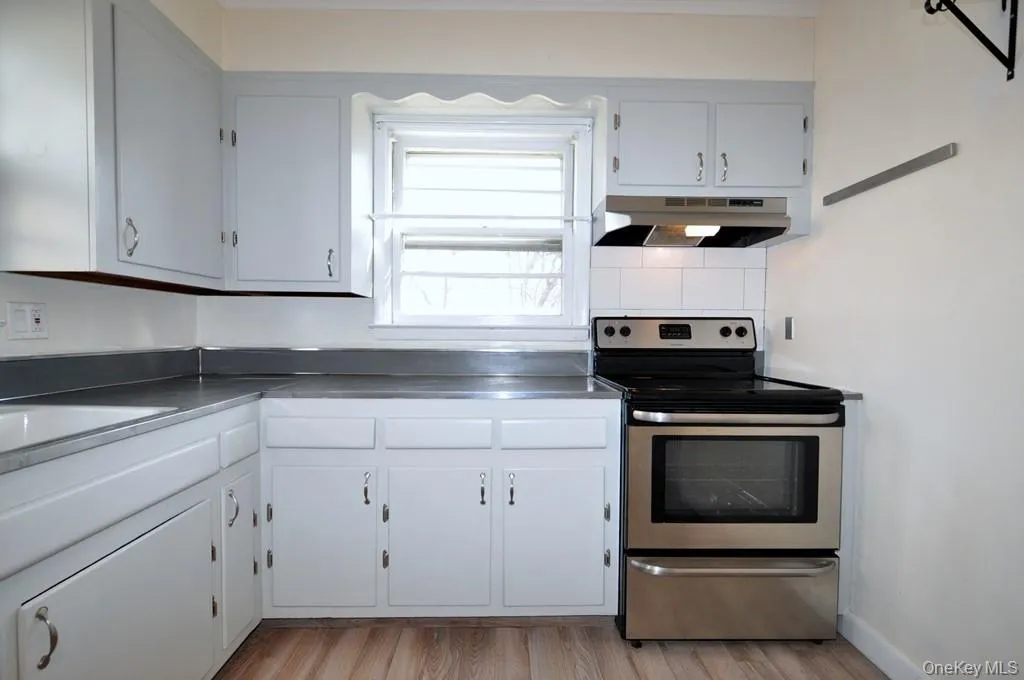 Large Eat-in Kitchen with a stainless steel range and refrigerator. Large Eat-in Kitchen with a stainless steel range and refrigerator.