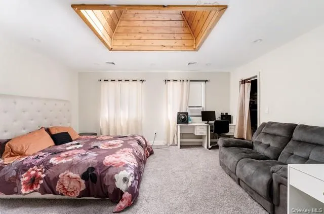 Second floor bedroom One with carpeted floor, skylight and walk-in closet, french door entry Second floor bedroom One with carpeted floor, skylight and walk-in closet, french door entry