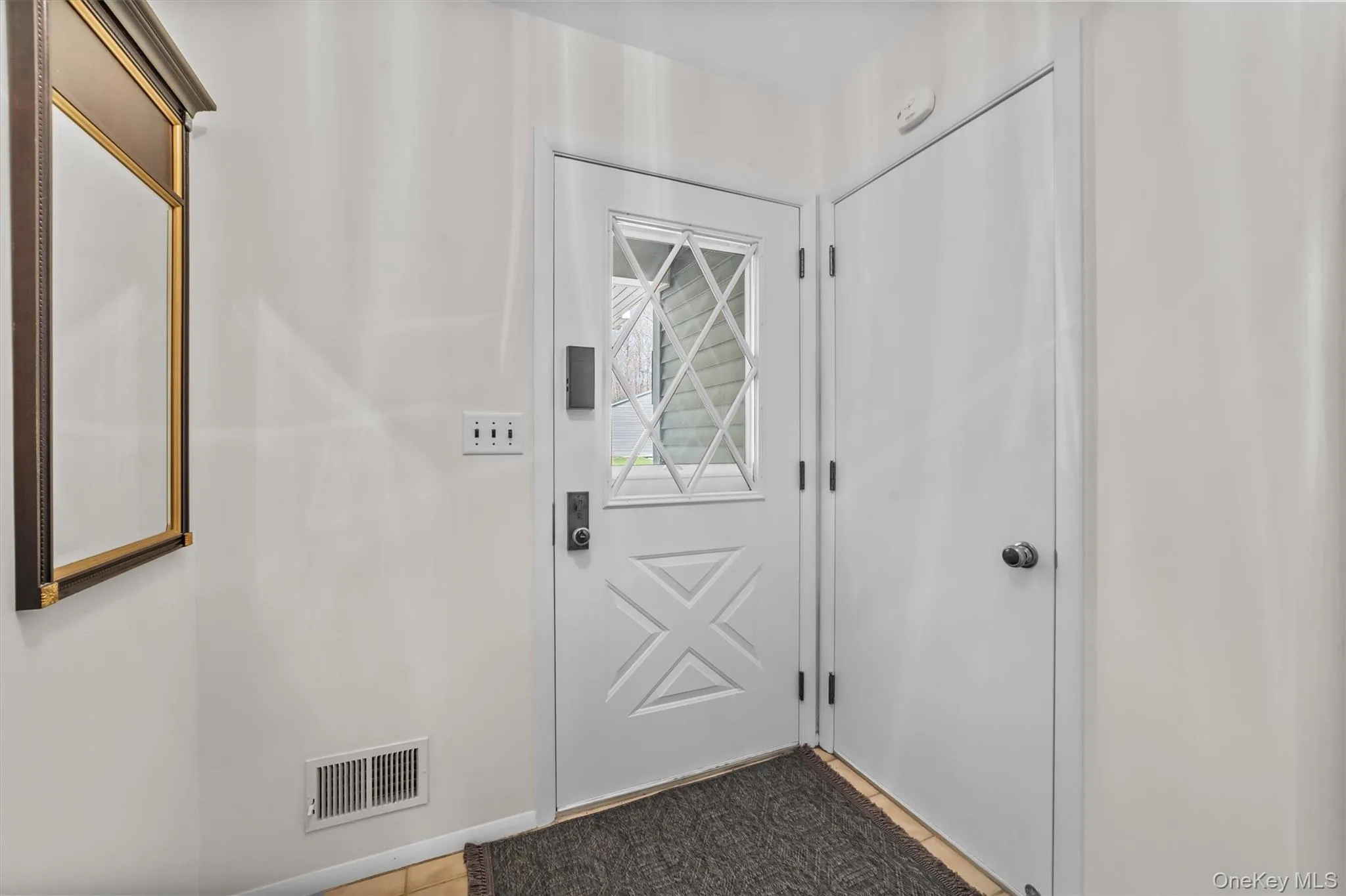 Entryway to a large closet and tiles hallway. Entryway to a large closet and tiles hallway.
