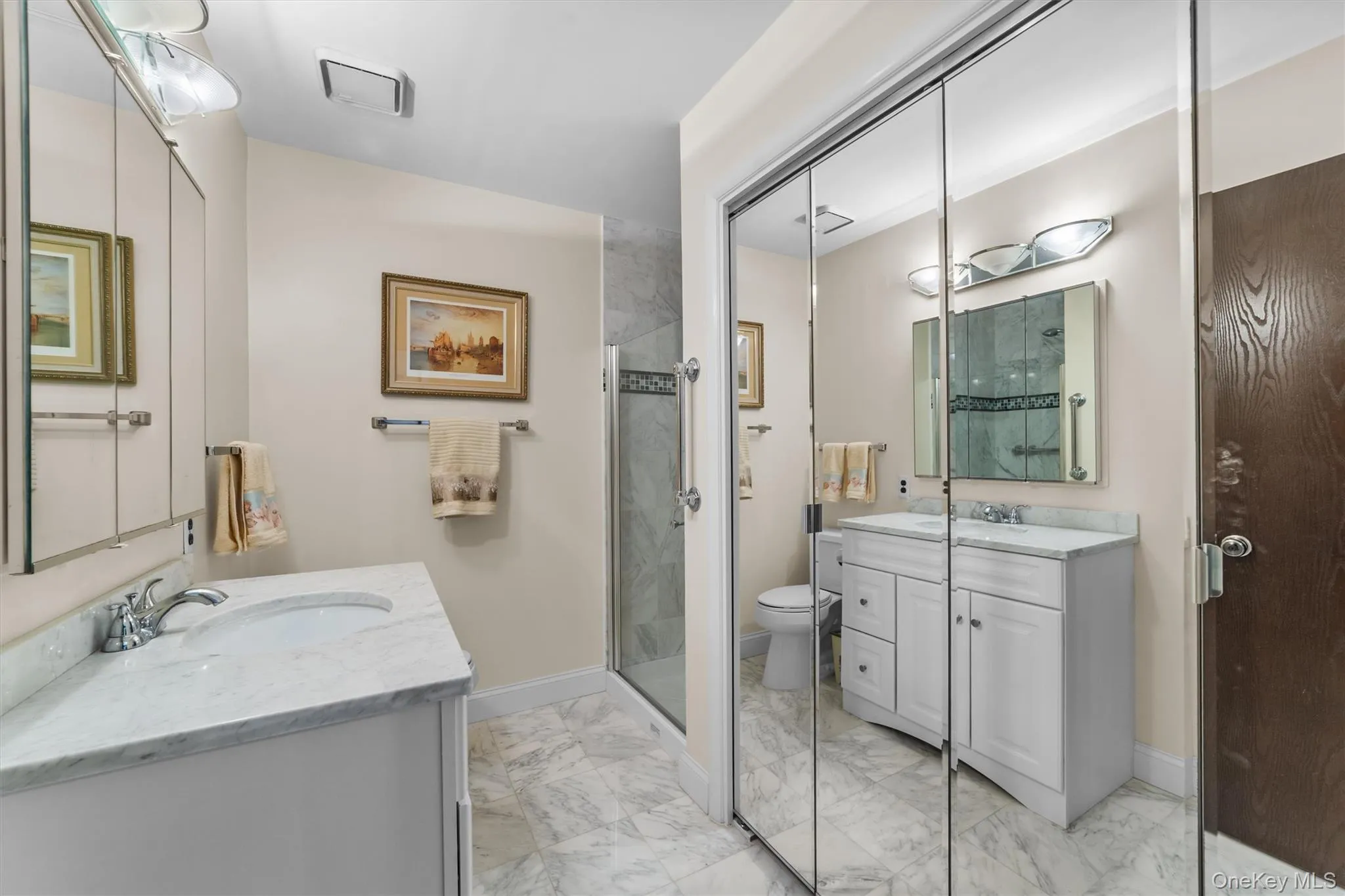Designer details in this Full Hall bathroom with vanity, marble like finish floor, and a shower stall Designer details in this Full Hall bathroom with vanity, marble like finish floor, and a shower stall