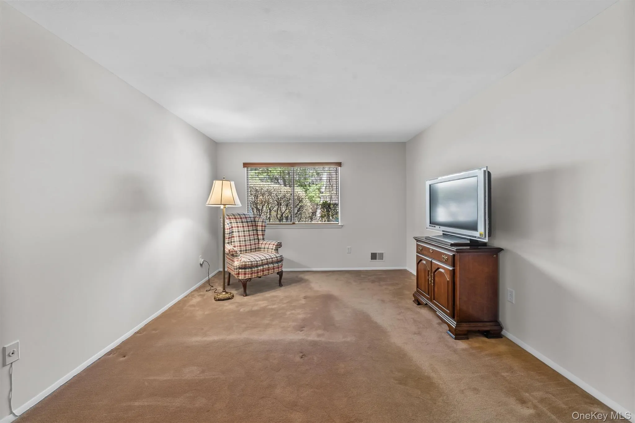 Master bedroom with carpet flooring and room for a king size bed. Master bedroom with carpet flooring and room for a king size bed.