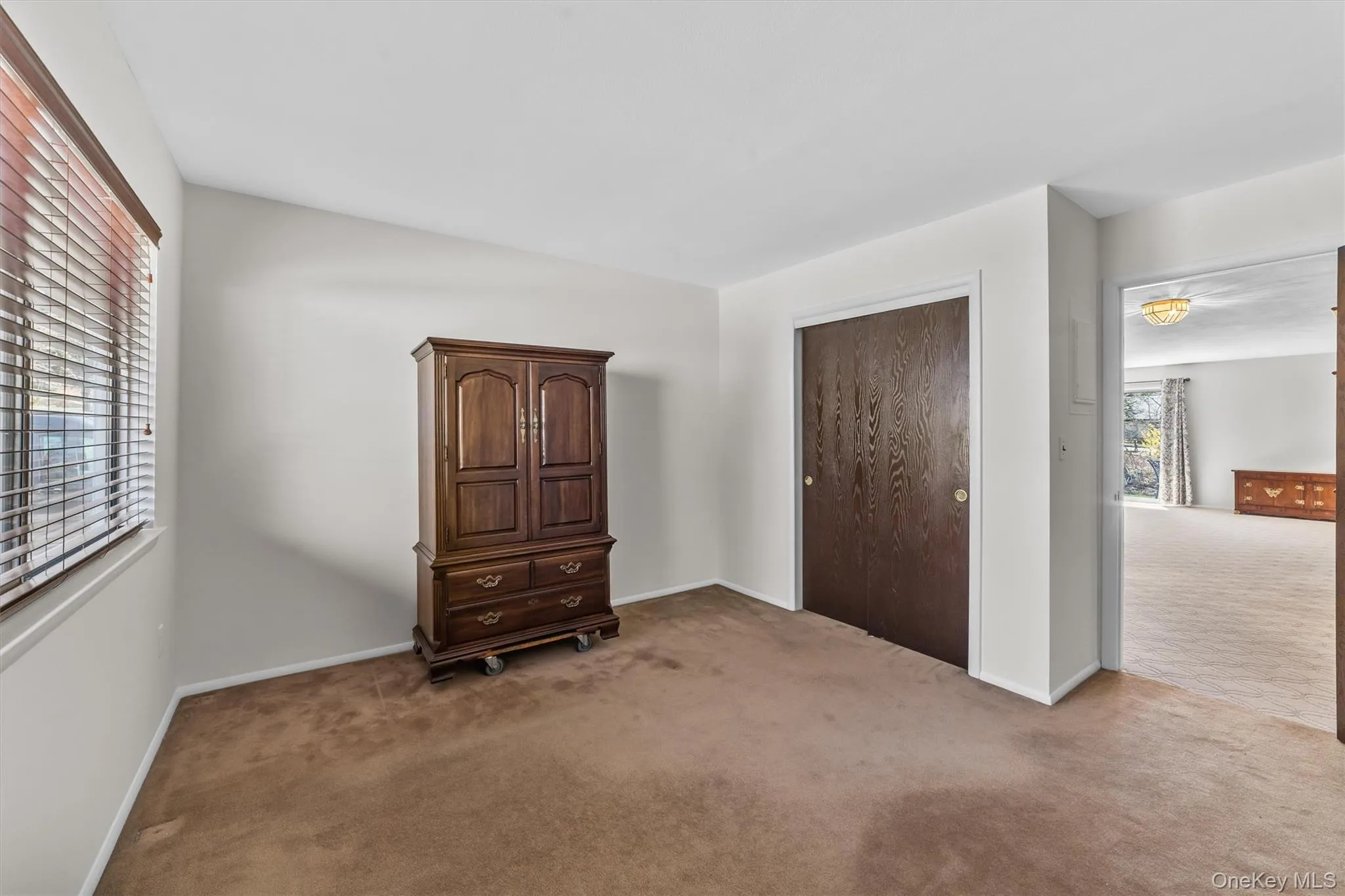 Second Bedroom carpeted and a double closet with sliding doors. Second Bedroom carpeted and a double closet with sliding doors.