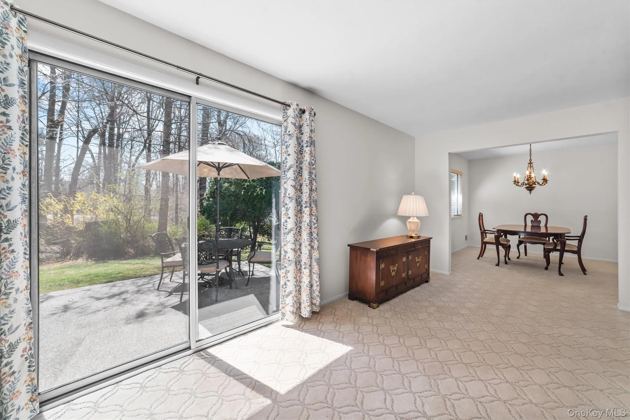 Living room with oversized sliding glass doors to your private backyard space. Living room with oversized sliding glass doors to your private backyard space.