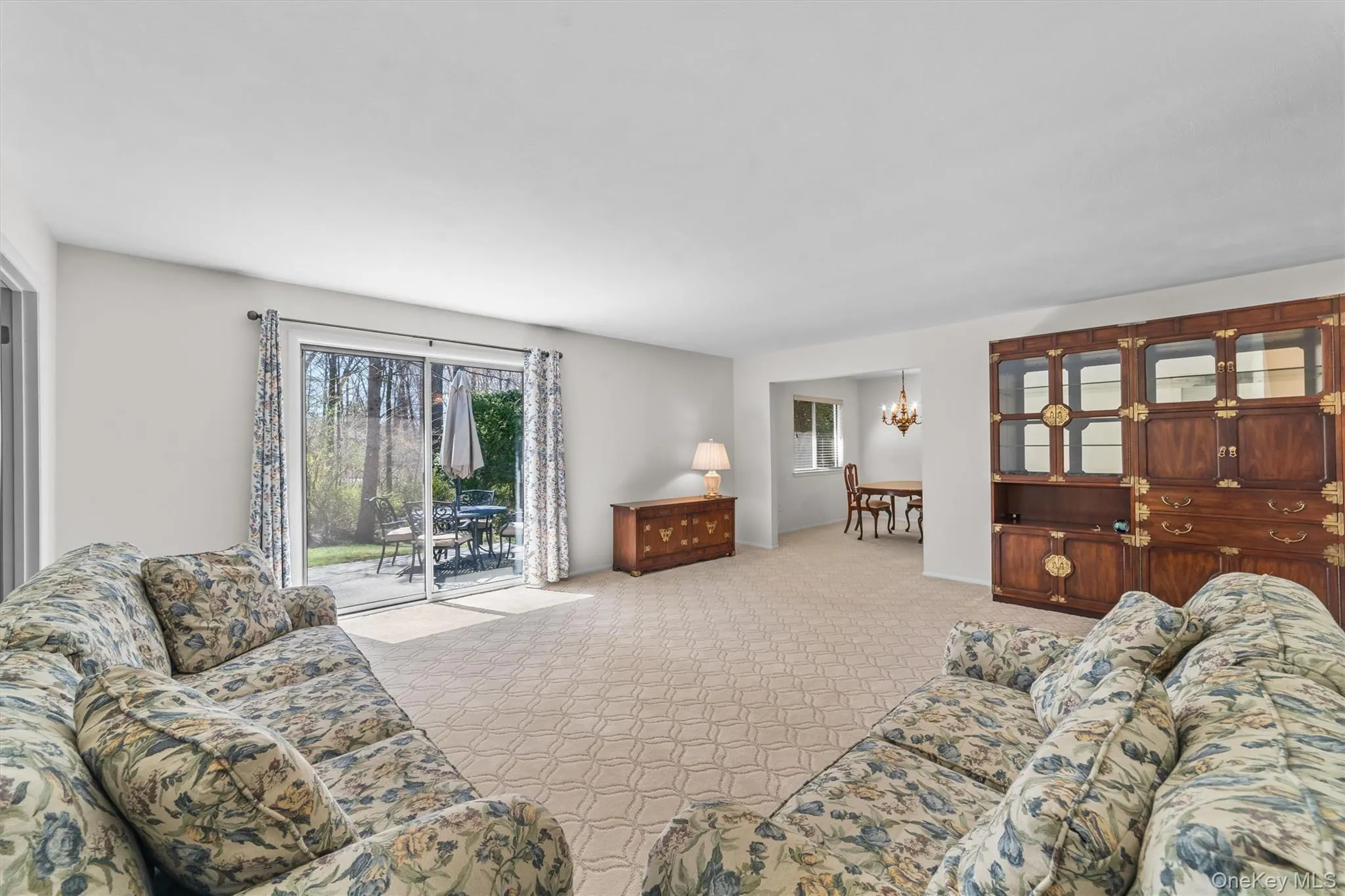 Living room featuring neutral carpeting and an open type concept feel. Living room featuring neutral carpeting and an open type concept feel.
