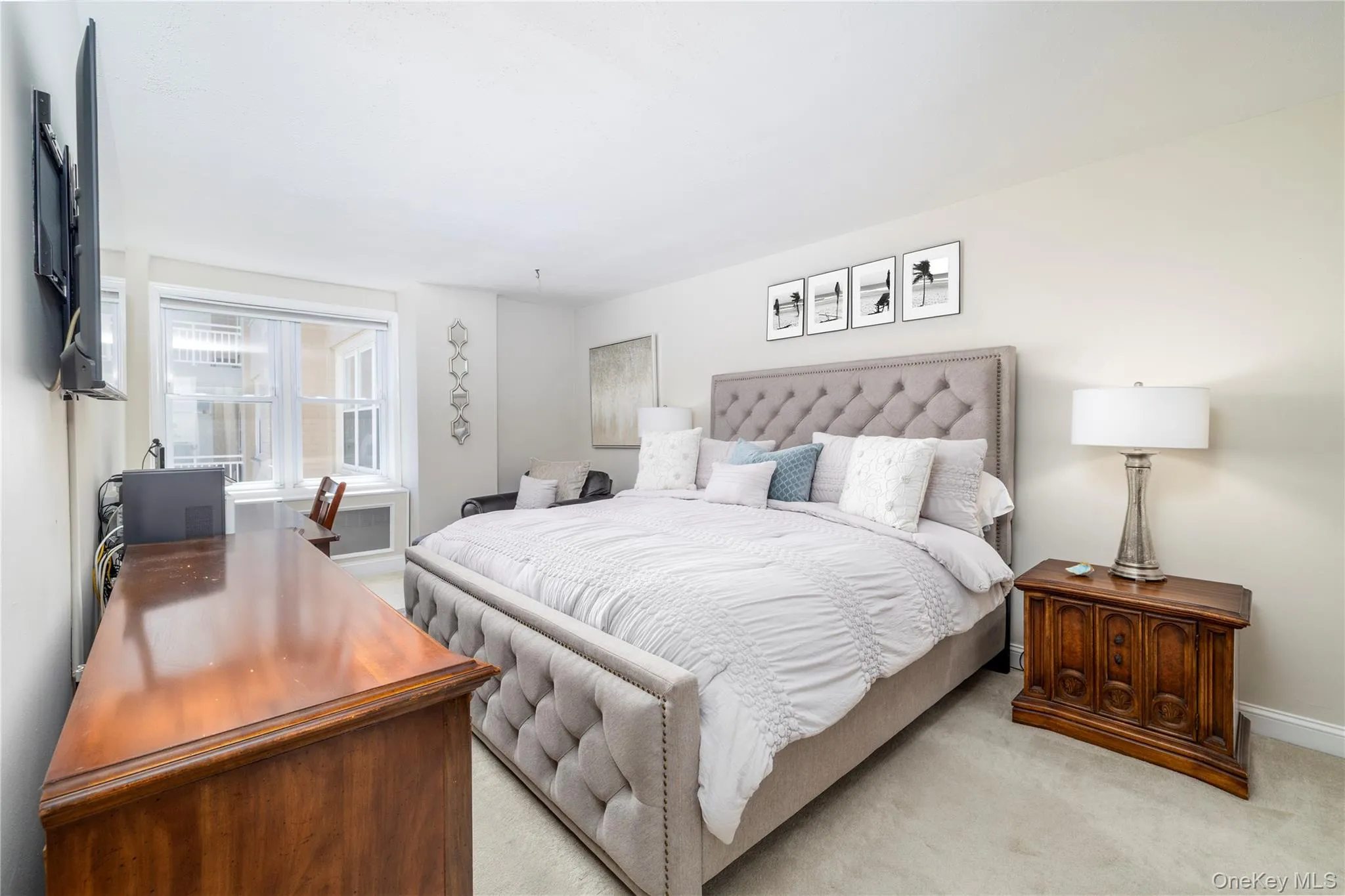 Bedroom featuring baseboards and light colored carpet Bedroom featuring baseboards and light colored carpet