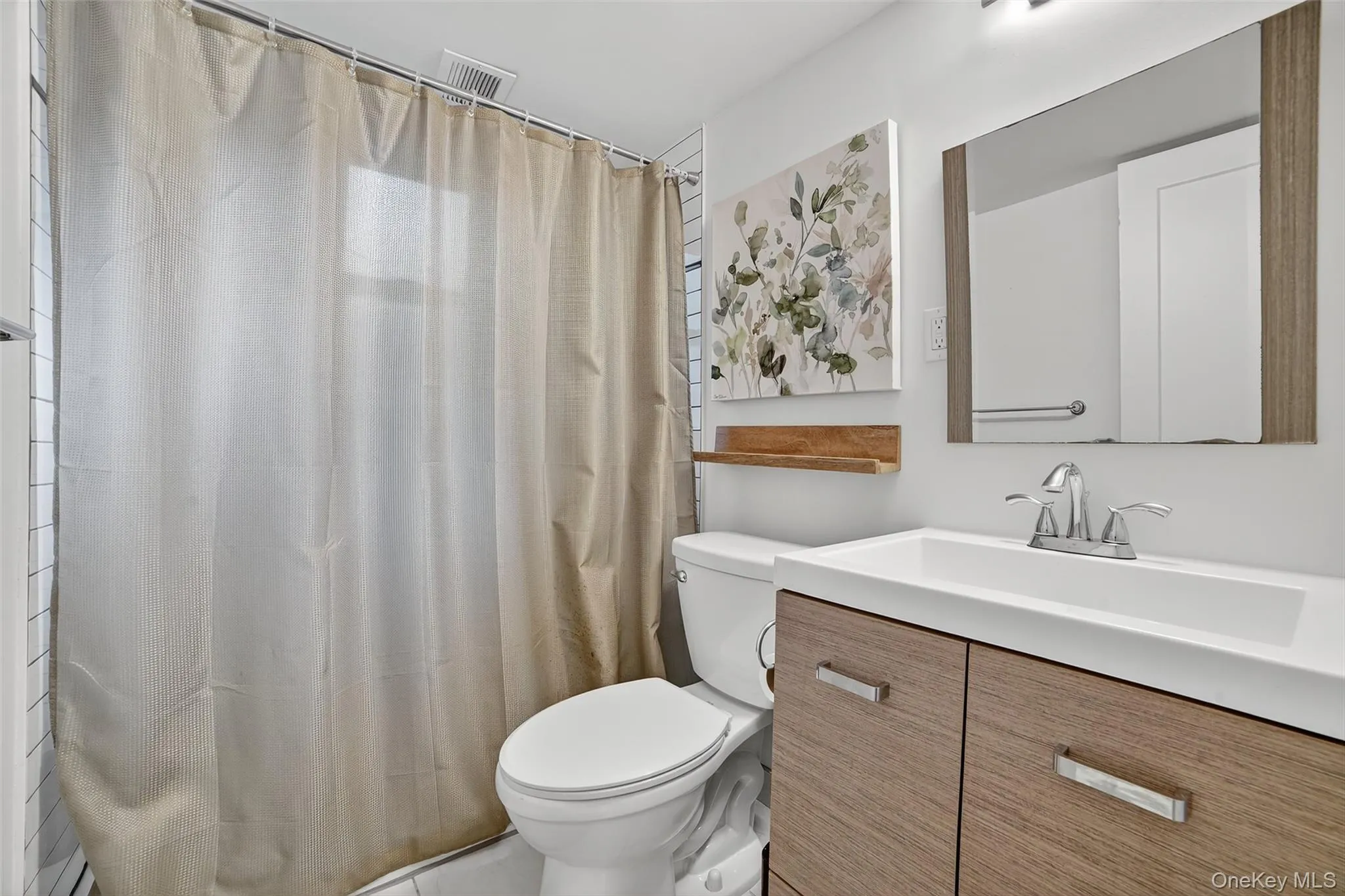 Full bathroom with vanity and a shower with shower curtain Full bathroom with vanity and a shower with shower curtain