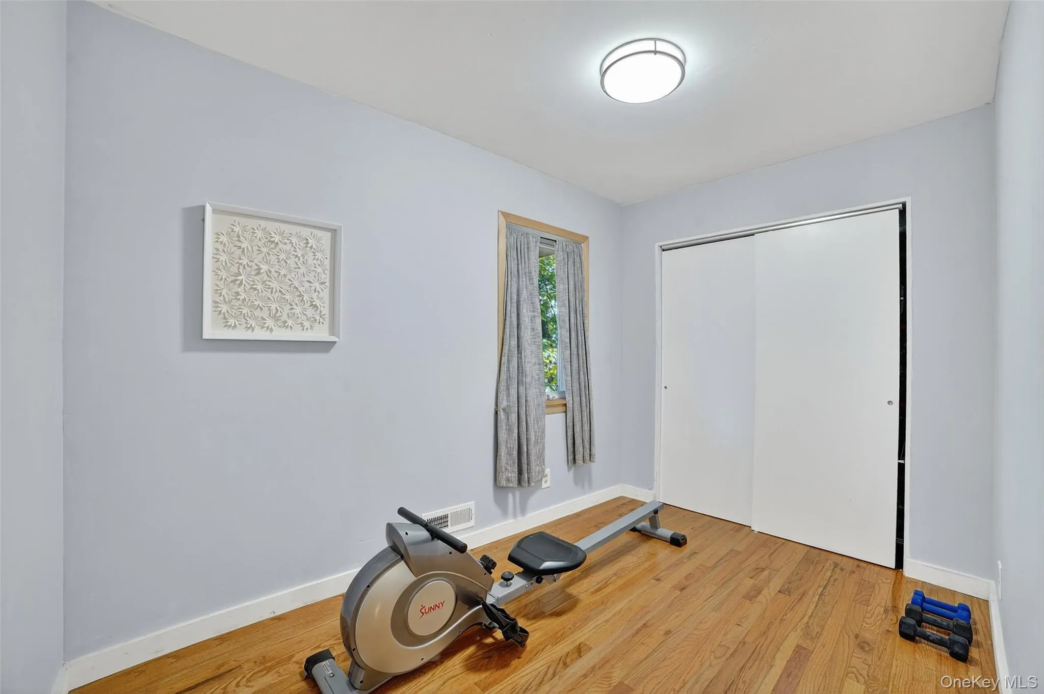 Lower Level room with light wood-style floors and baseboards Lower Level room with light wood-style floors and baseboards