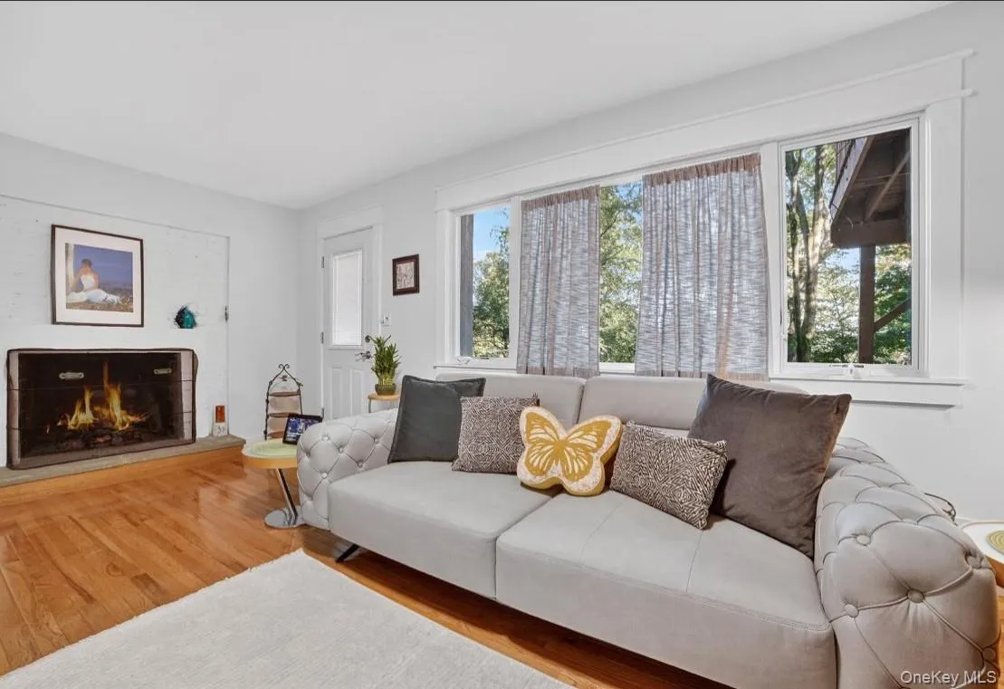 Lower Level area featuring wood finished floors and a lit fireplace Lower Level area featuring wood finished floors and a lit fireplace