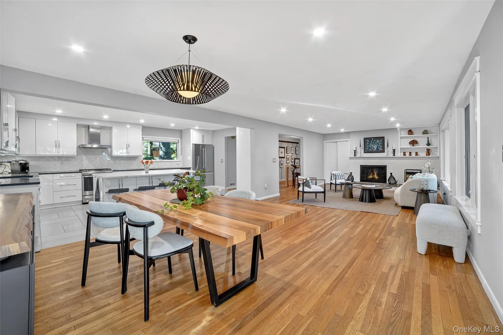 Dining room featuring recessed lighting, light wood-type flooring, and a glass covered fireplace Dining room featuring recessed lighting, light wood-type flooring, and a glass covered fireplace