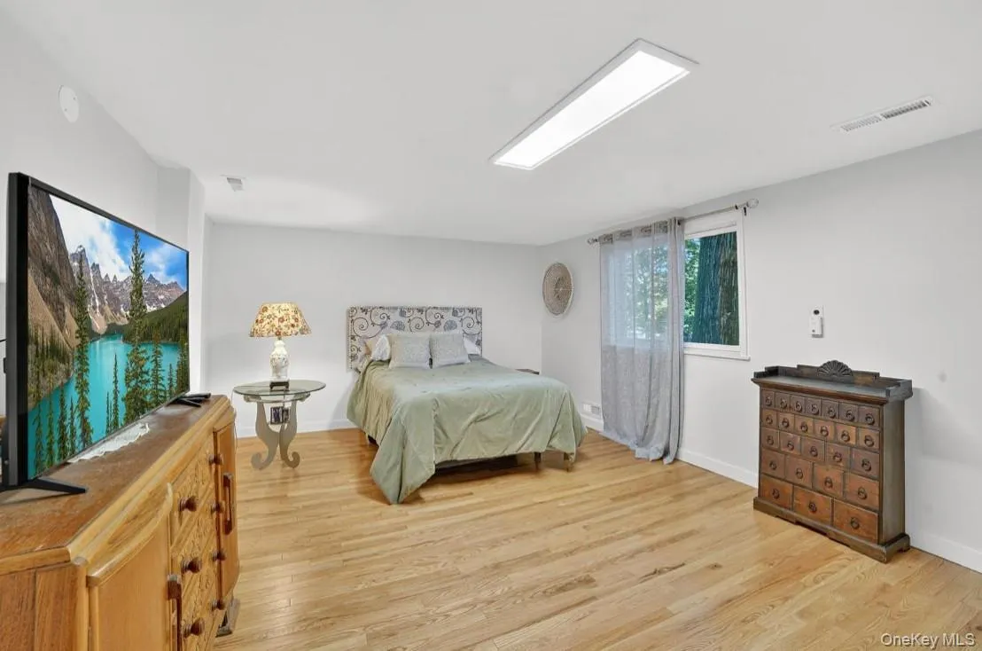 Bedroom featuring light wood finished floors and baseboards Bedroom featuring light wood finished floors and baseboards