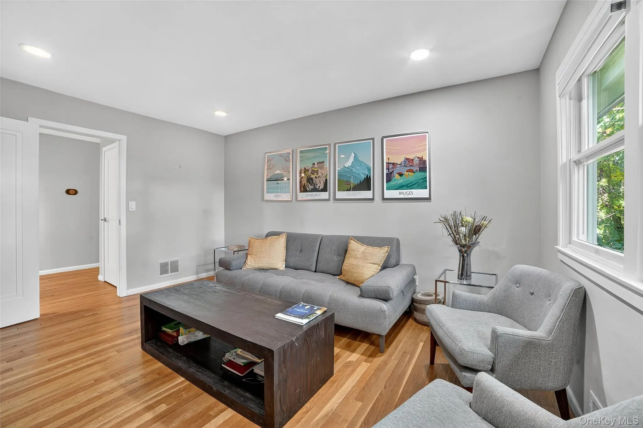 Living room featuring light wood-type flooring and recessed lighting Living room featuring light wood-type flooring and recessed lighting