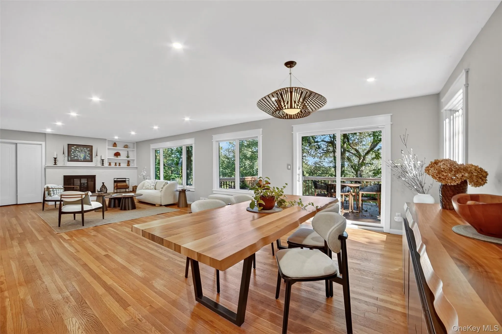 Dining space featuring recessed lighting, light wood-style floors, plenty of natural light, and a glass covered fireplace Dining space featuring recessed lighting, light wood-style floors, plenty of natural light, and a glass covered fireplace
