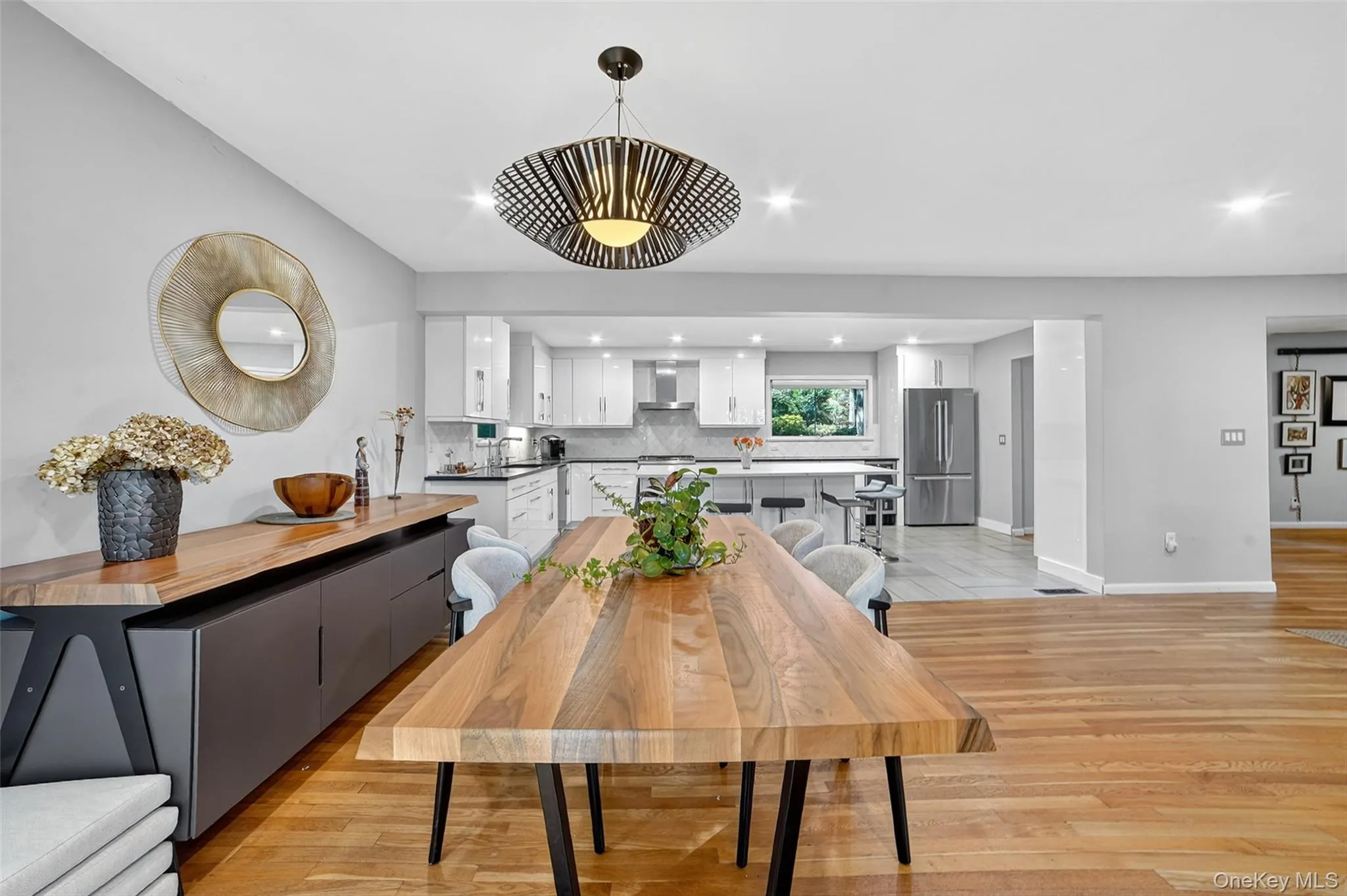 Dining room featuring light wood-style flooring and recessed lighting Dining room featuring light wood-style flooring and recessed lighting
