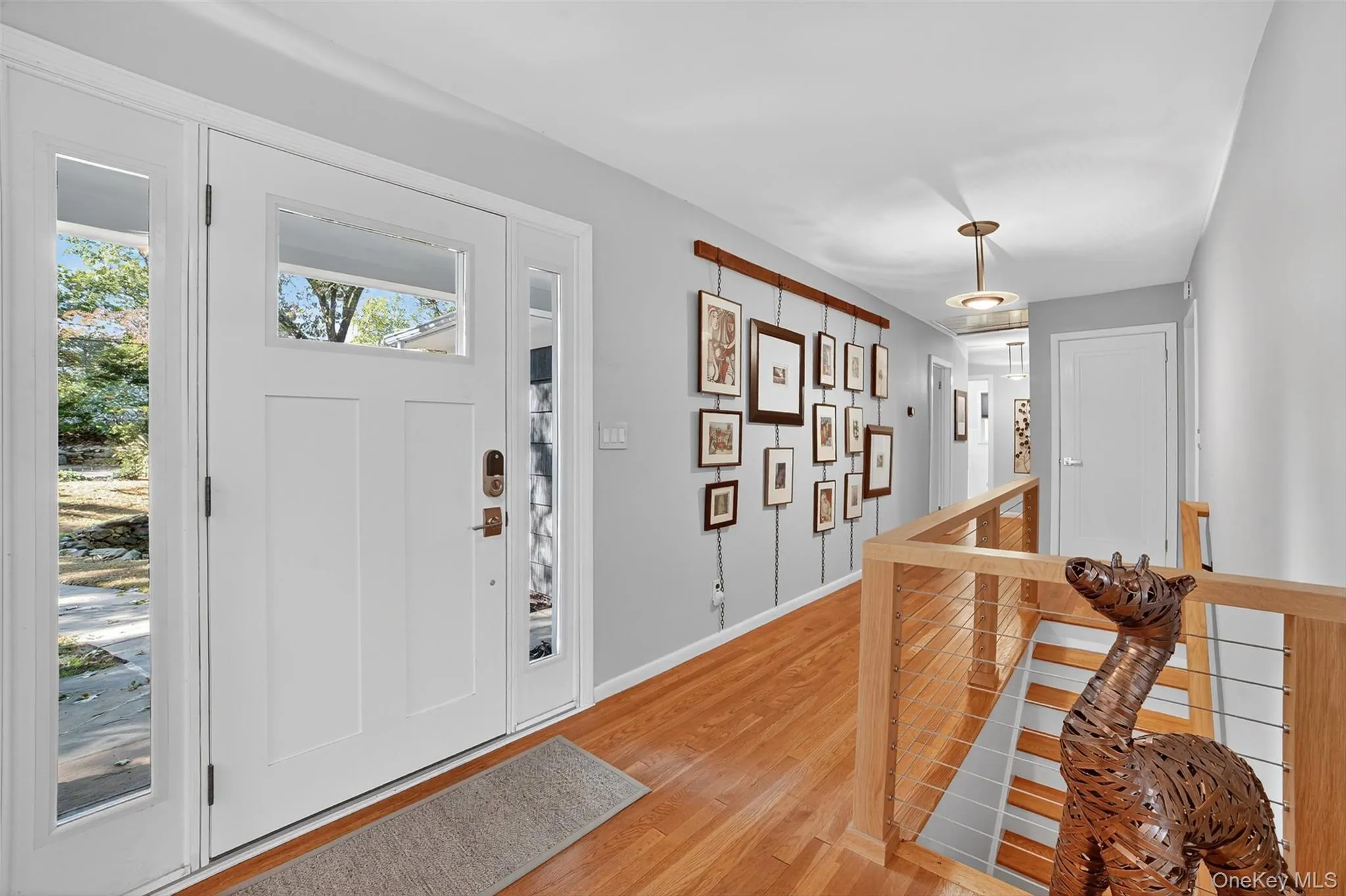 Entryway with light wood-style floors and baseboards Entryway with light wood-style floors and baseboards
