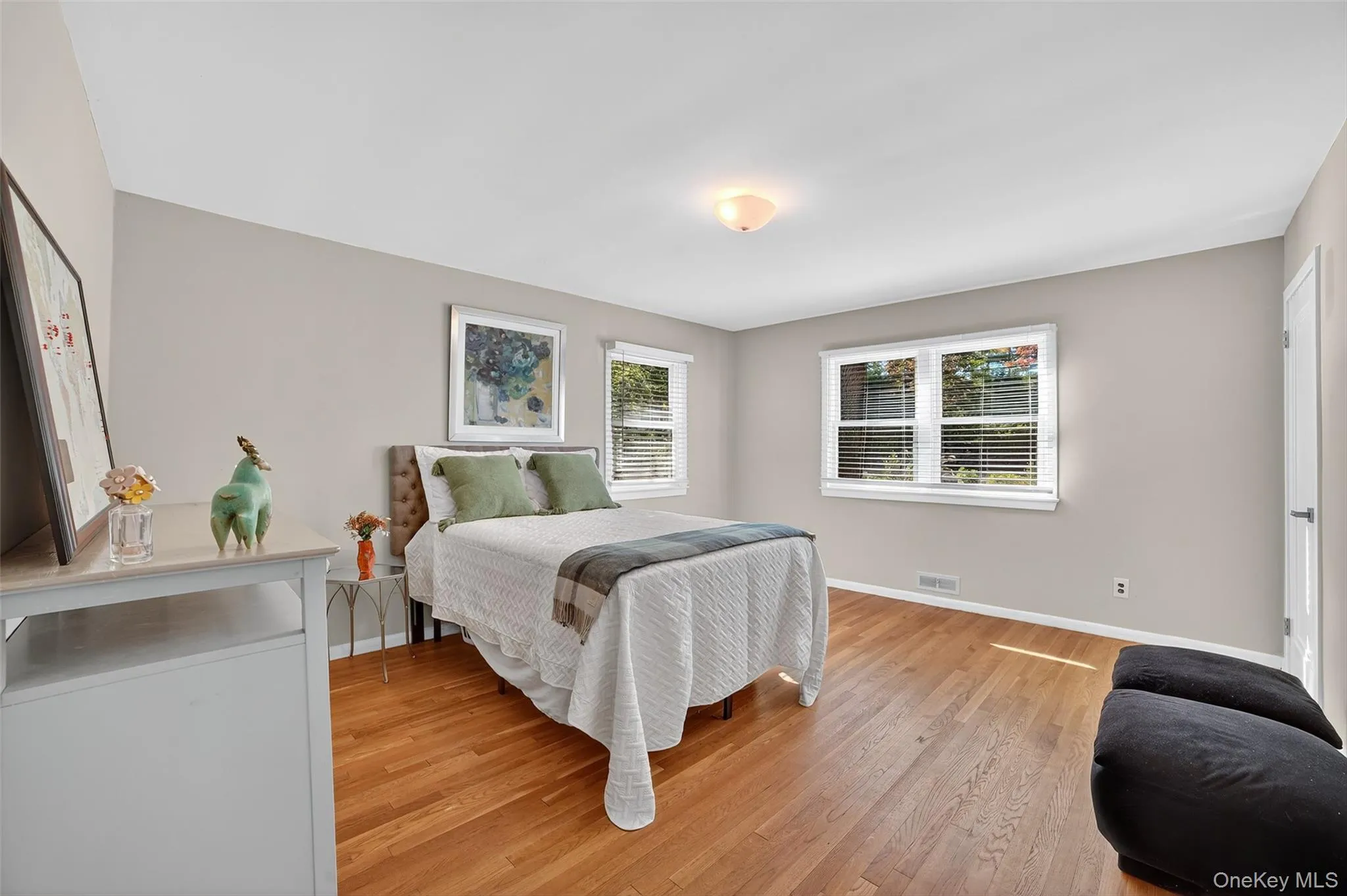 Bedroom with light wood finished floors and baseboards Bedroom with light wood finished floors and baseboards