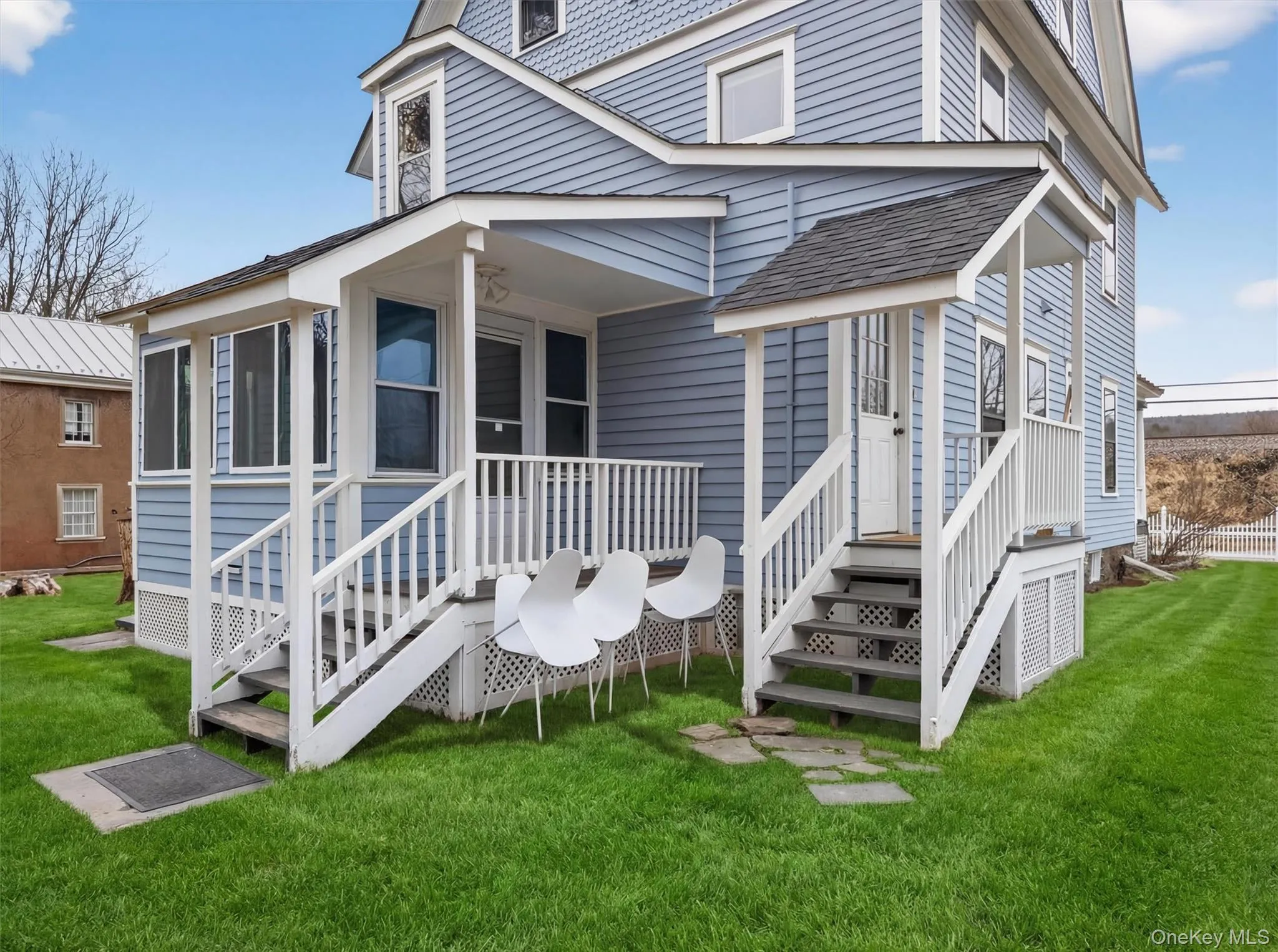 Rear view of property featuring a lawn Rear view of property featuring a lawn
