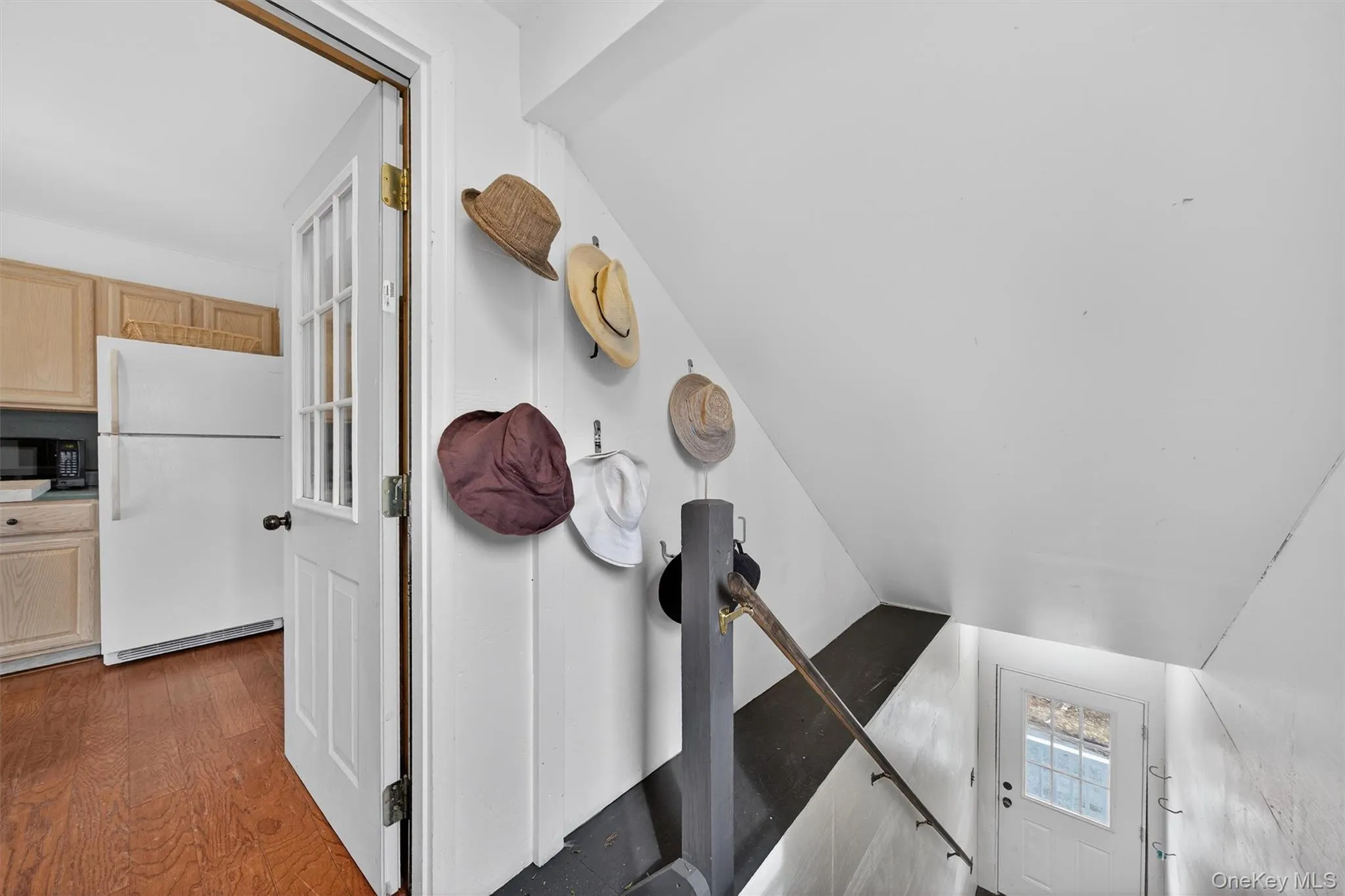 Staircase going to the second floor, possible apartment, enters into the kitchen. Staircase going to the second floor, possible apartment, enters into the kitchen.