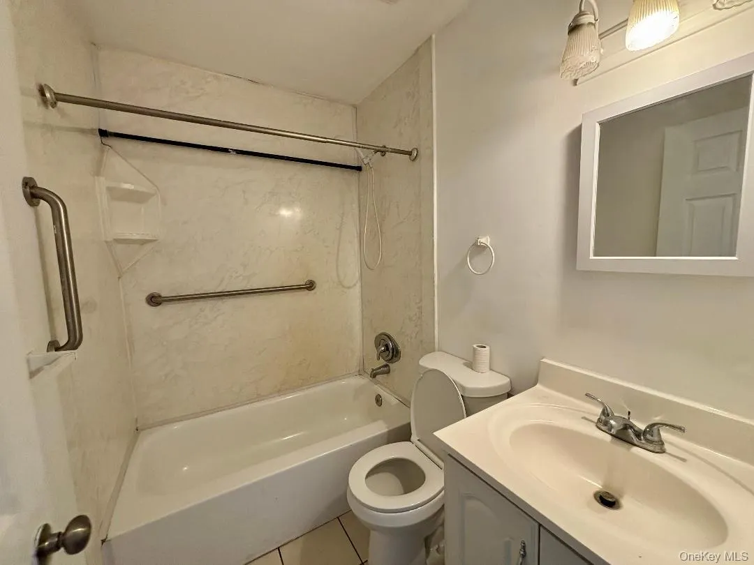 Bathroom with vanity, shower combination, and tile patterned flooring Bathroom with vanity, shower combination, and tile patterned flooring