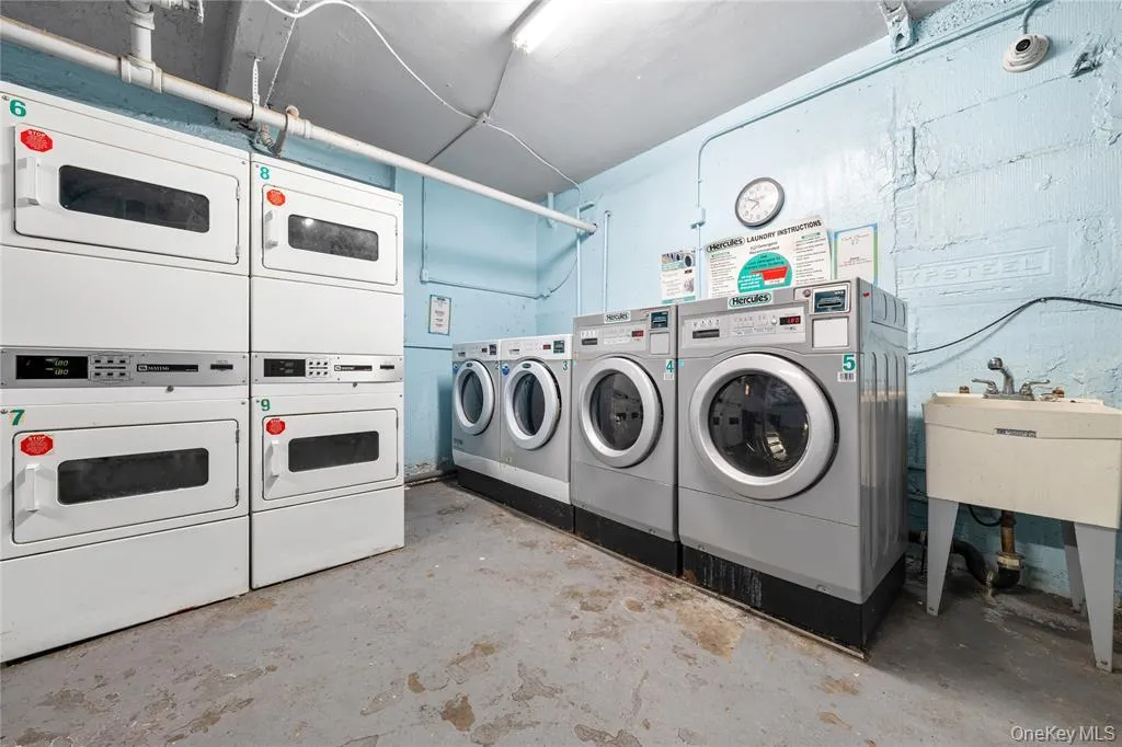 Shared laundry room featuring washing machine and dryer and stacked washer / dryer Shared laundry room featuring washing machine and dryer and stacked washer / dryer