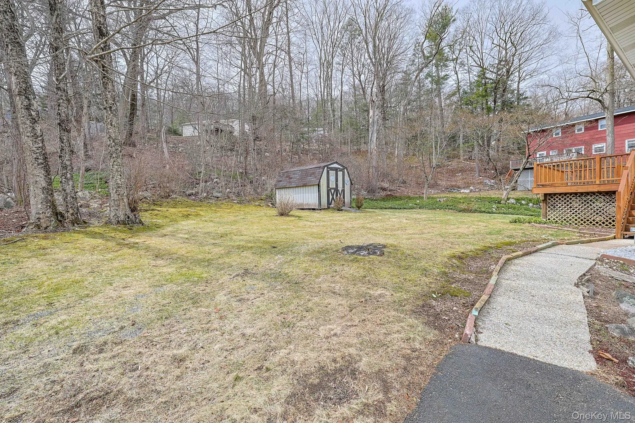 View of backyard and walk way to back deck. View of backyard and walk way to back deck.