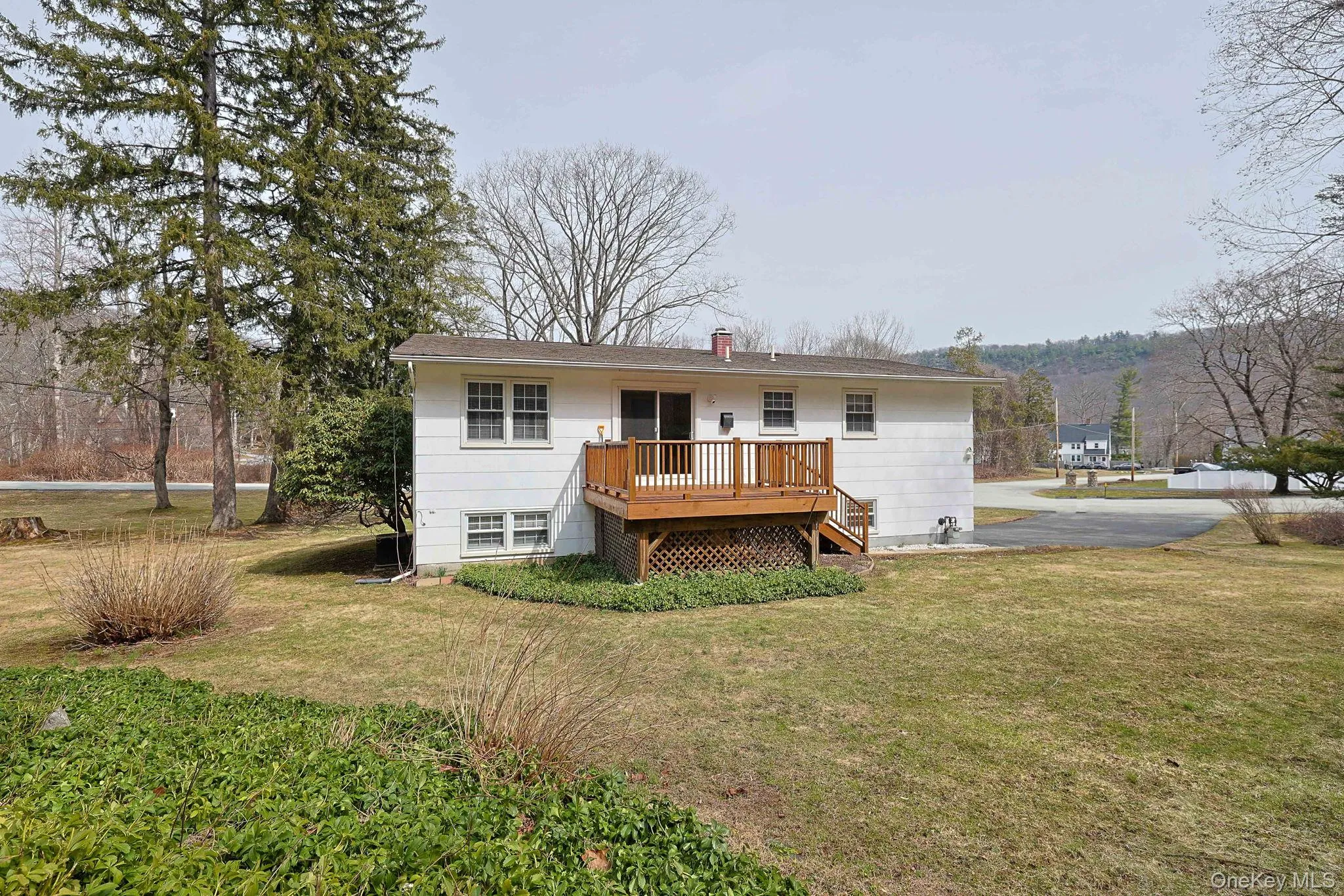 View of back of home with deck and back yard View of back of home with deck and back yard