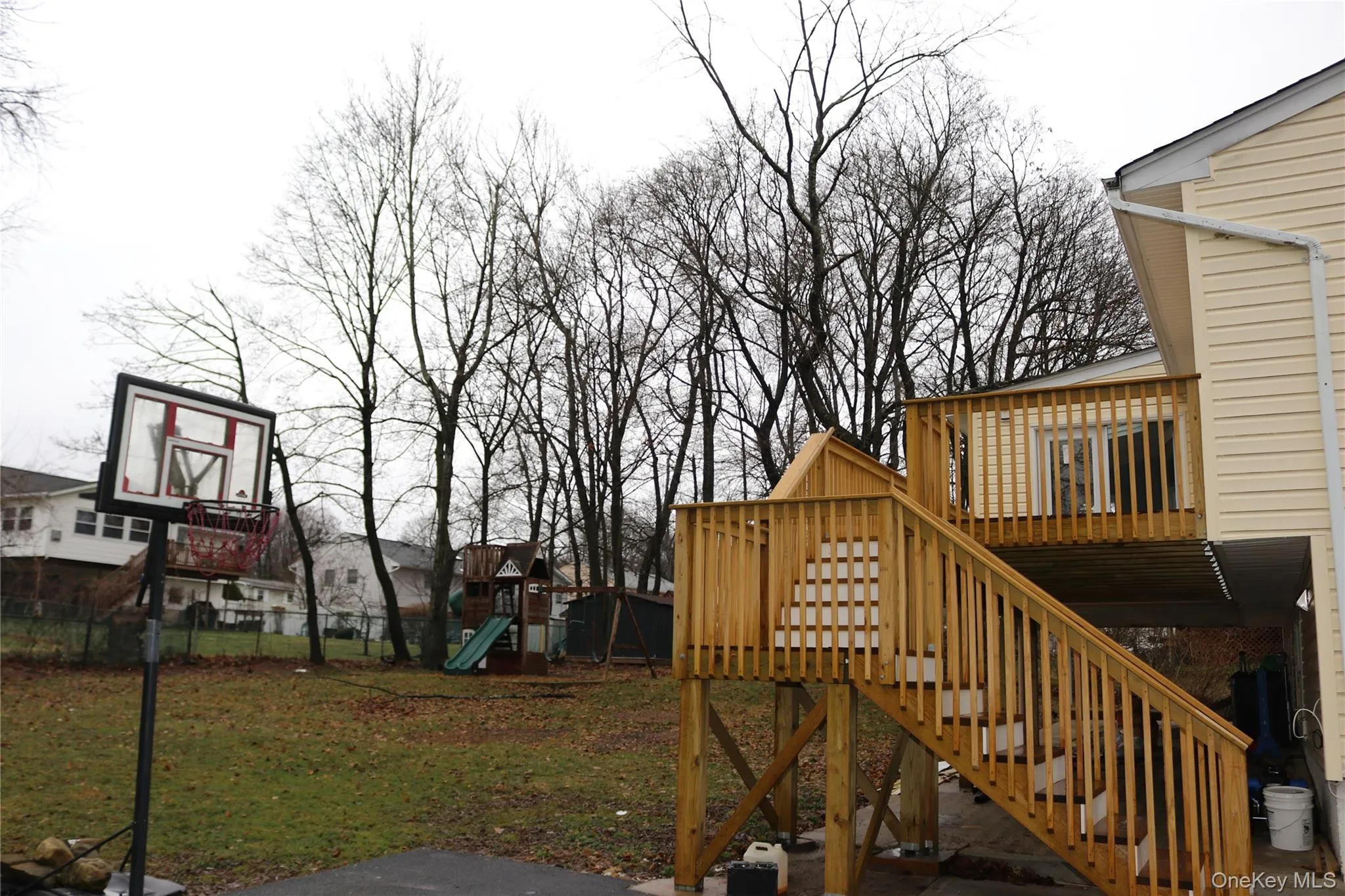 View of yard with a wooden deck and a playground View of yard with a wooden deck and a playground